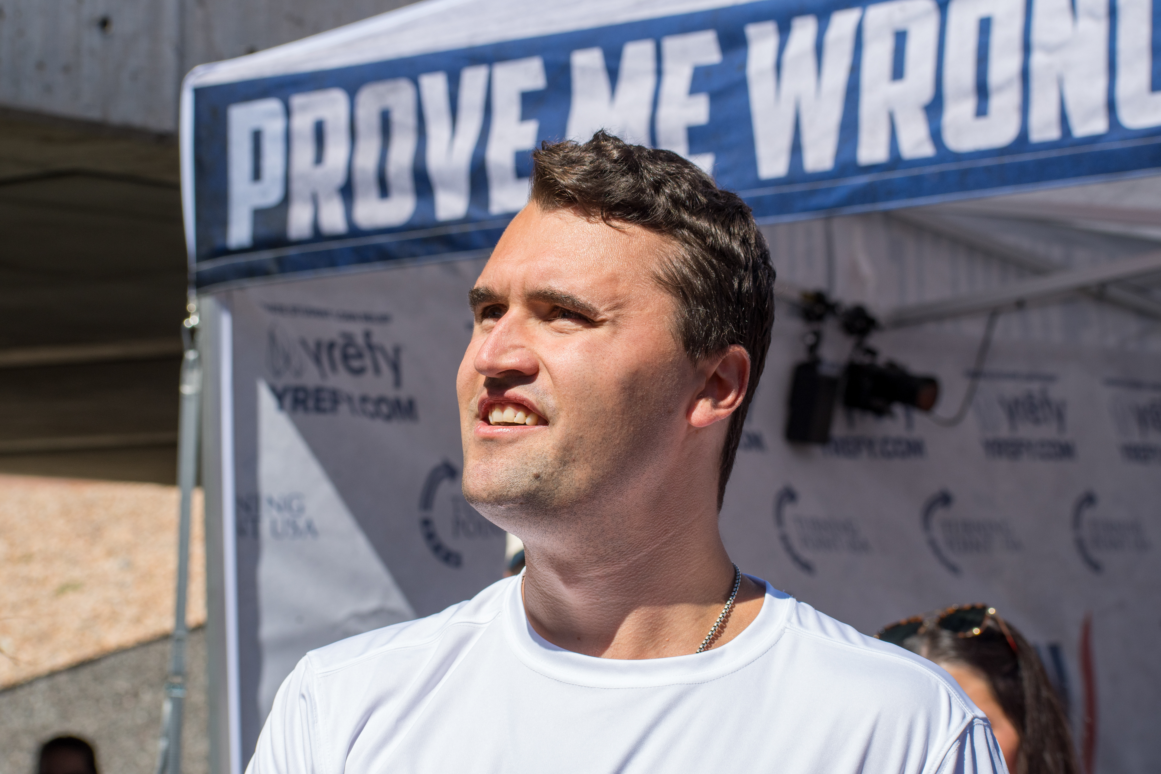 OREM, UTAH – SEPTEMBER 10, 2025: Charlie Kirk speaks with attendees during a public event at Utah Valley University. Positioned near a promotional booth and surrounded by supporters, Kirk appears engaged and expressive in one of his final public moments. The image reflects the atmosphere of direct outreach and energized dialogue that defined the gathering. © Charles-McClintock Wilson / ZUMA Press