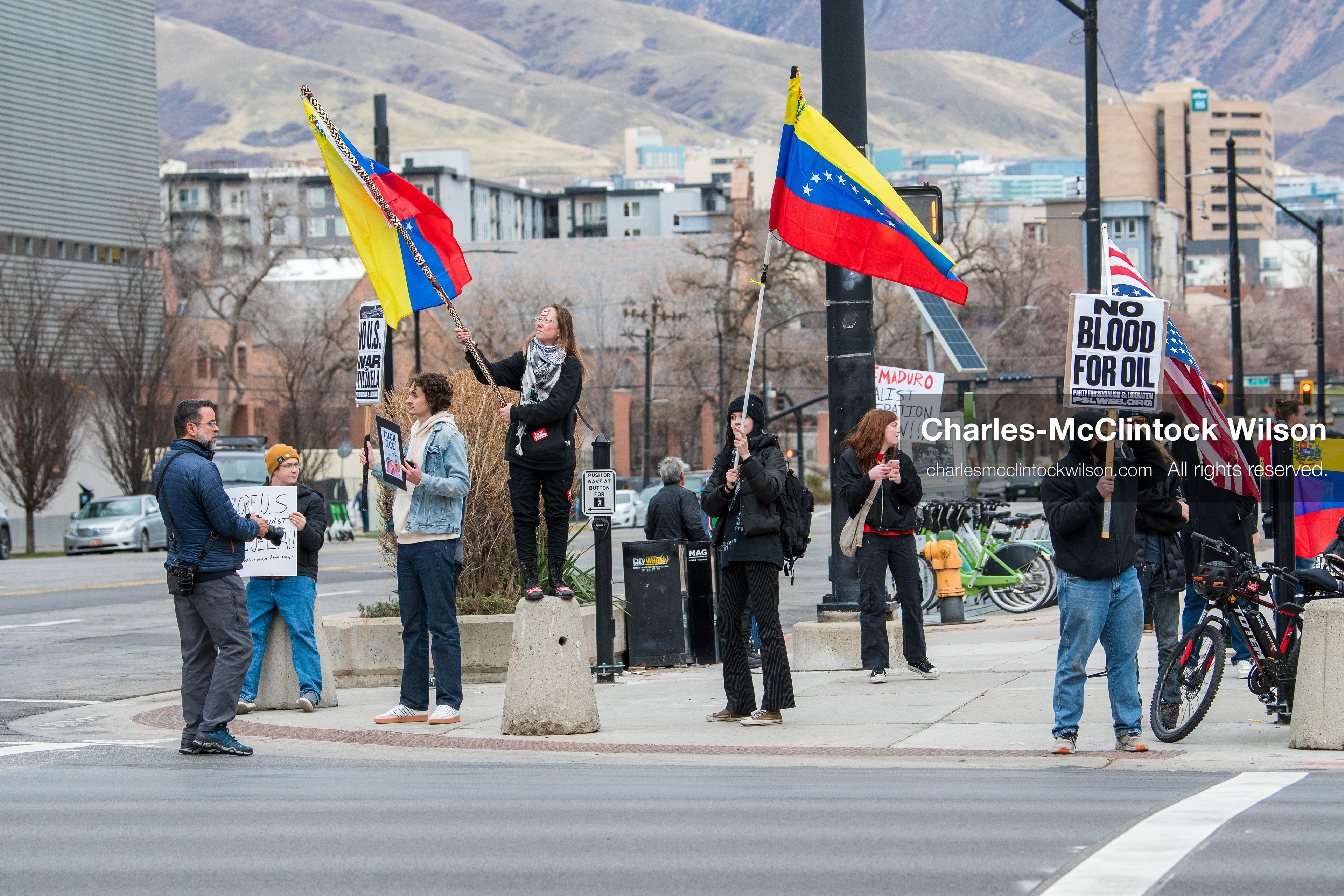 January 3, 2026, Salt Lake City, Utah, USA: Protesters hold signs and flags, including the Venezuelan flag, during a demonstration against US action in Venezuela outside the Wallace Federal Building in Salt Lake City, Utah. The protest was part of a nationwide mobilization responding to recent military developments. (Credit Image: (c) Charles‑McClintock Wilson/ZUMA Press Wire)