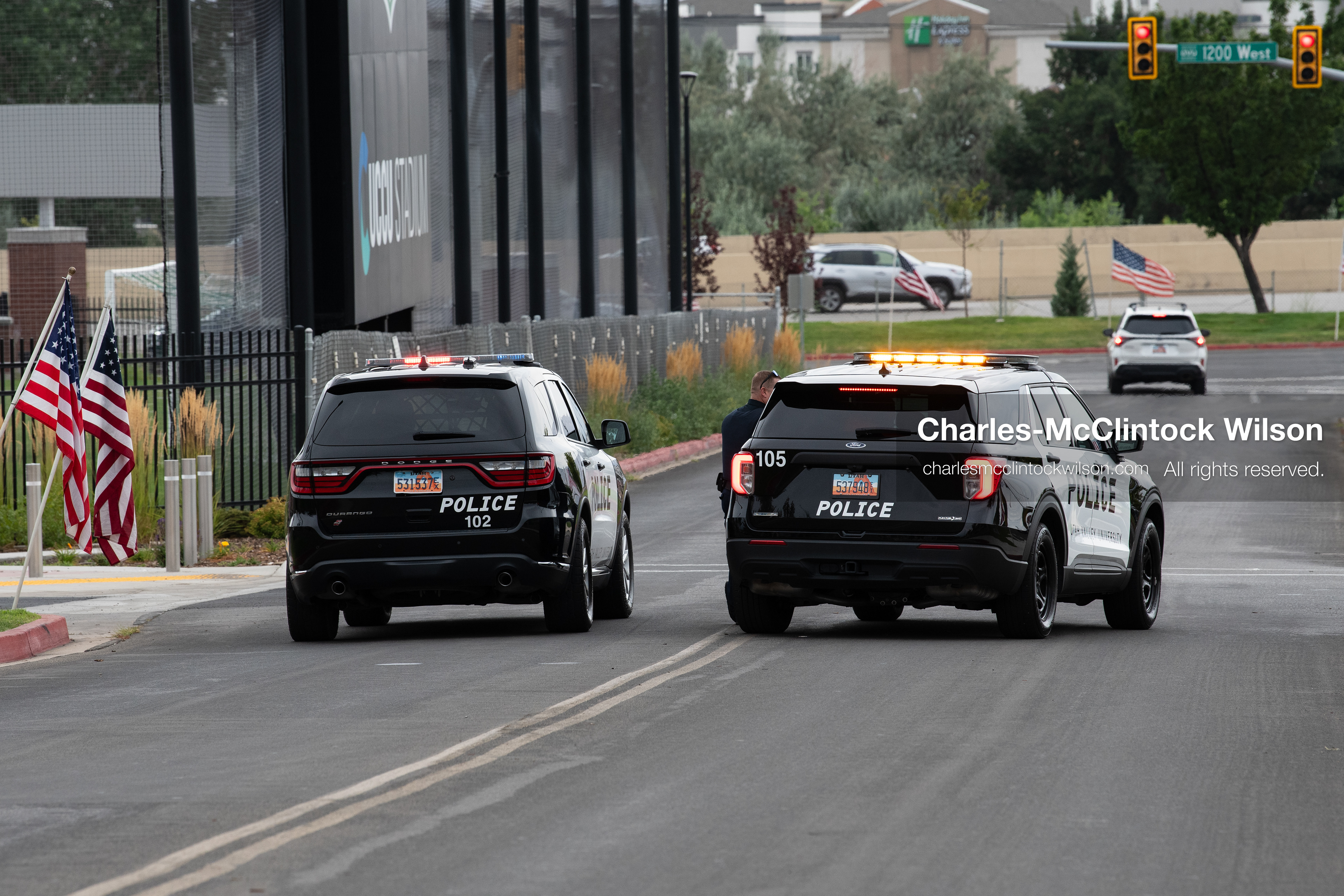 Law enforcement vehicles drive along a roadway outside the UCCU Center at Utah Valley University in Orem, Utah, on Wednesday, July 29, 2026. More than 300 people came to the public memorial ceremony to honor Provo Fire Captain Spencer Long, his wife Katrina, and three of their sons, who died after a flash flood hit their campsite near the Sunglow Campground in Wayne County. (Photo by Charles-McClintock Wilson/Sipa USA)