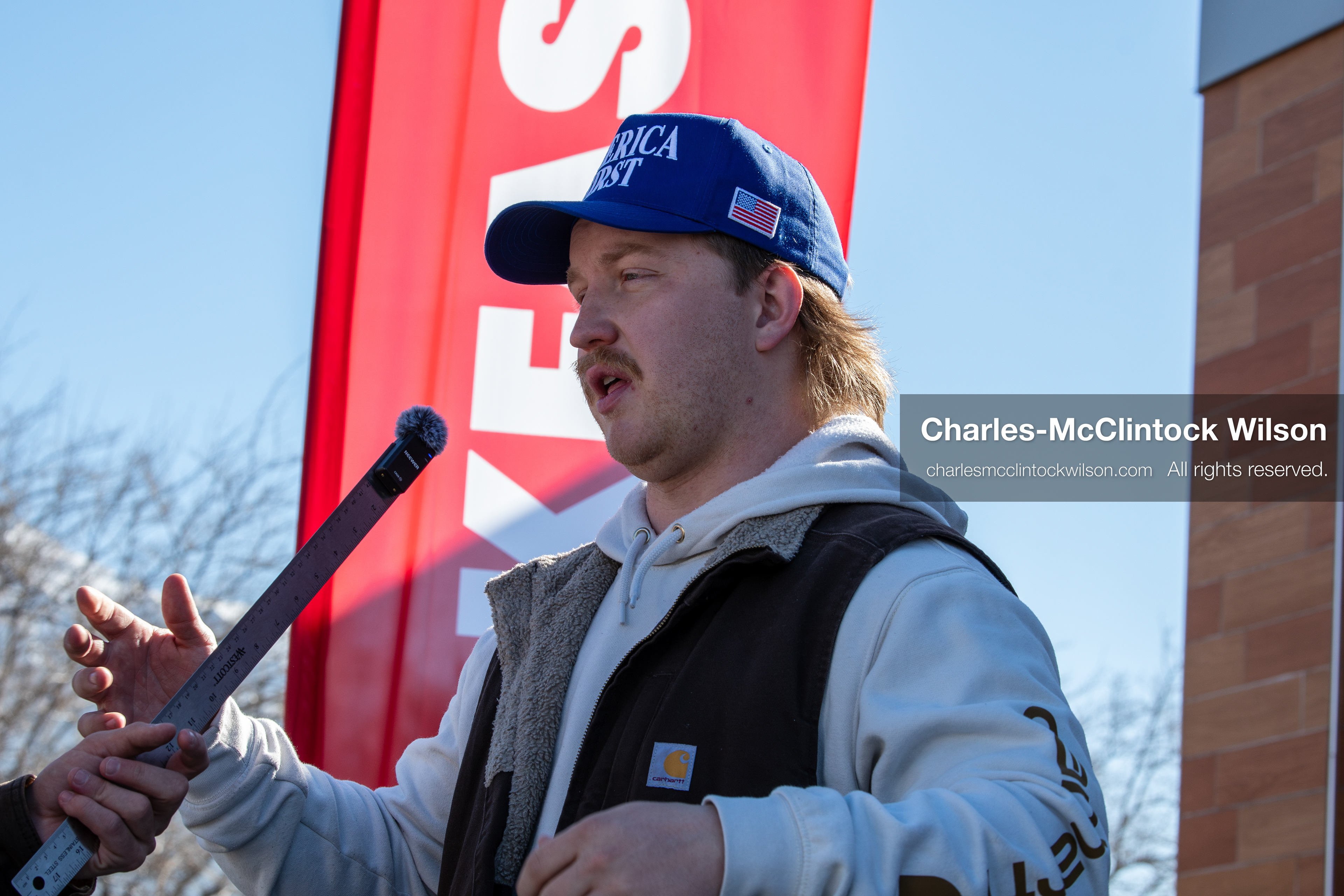 February 5, 2026, Provo, Utah, USA: A person wearing an America First hat speaks into a microphone near Brigham Young University in Provo during a gathering opposing the presence of US Customs and Border Protection recruiters at a career fair held on the BYU campus. (Credit Image: © Charles McClintock Wilson/ZUMA Press Wire)