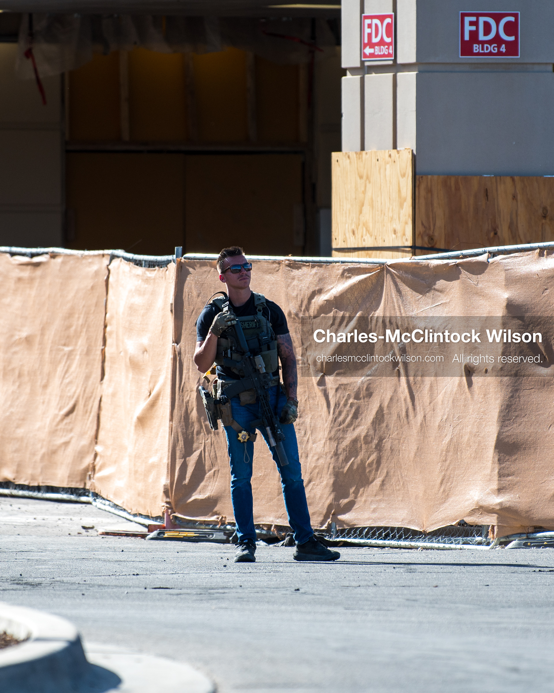 August 17, 2026, Murray, Utah, USA: An armed plainclothes investigator stands near a construction fence line outside Intermountain Medical Center on Monday. Multiple police agencies secured the hospital perimeter as a safety precaution after shooting victims were brought in from a fatal shootout outside a funeral in nearby Kearns. (Credit Image: © Charles McClintock Wilson/ZUMA Press Wire)