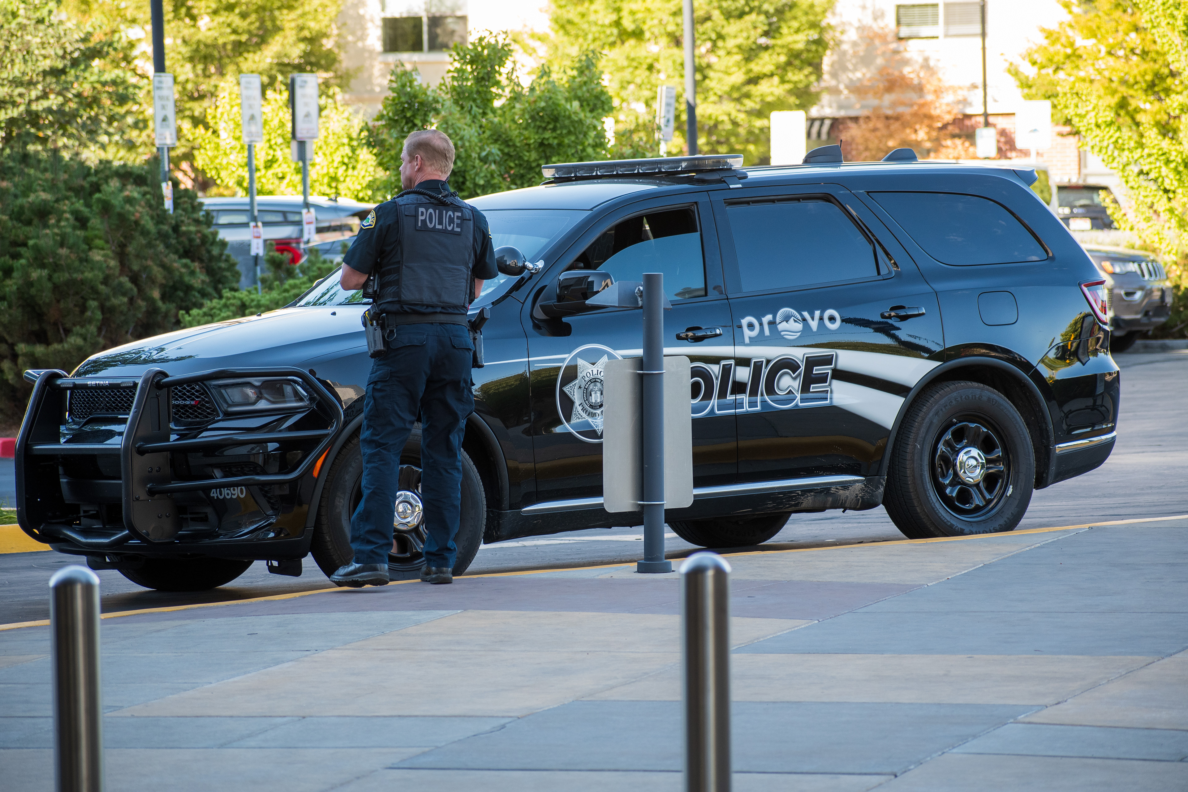September 15, 2025 – Provo, Utah, United States: A Provo Police Department officer stands beside a marked patrol vehicle near the Utah Valley Convention Center during a Department of Homeland Security career expo focused on recruiting law enforcement and security personnel. Photograph by Charles‑McClintock Wilson / ZUMA Press Wire