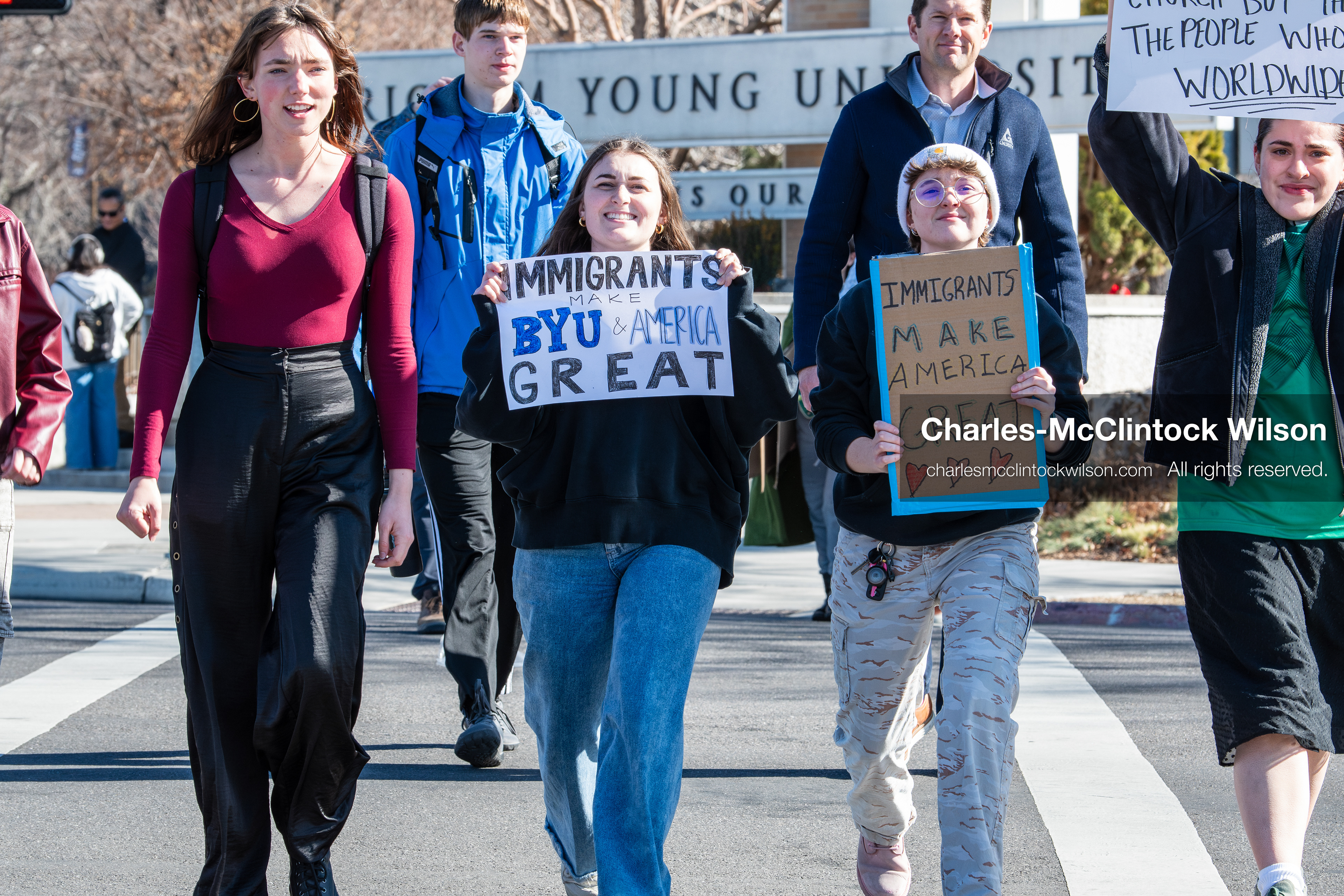 February 5, 2026, Provo, Utah, USA: People walk near the Brigham Young University entrance in Provo as demonstrators carrying signs gather to protest the presence of US Customs and Border Protection recruiters at a career fair held on the BYU campus. (Credit Image: © Charles McClintock Wilson/ZUMA Press Wire)