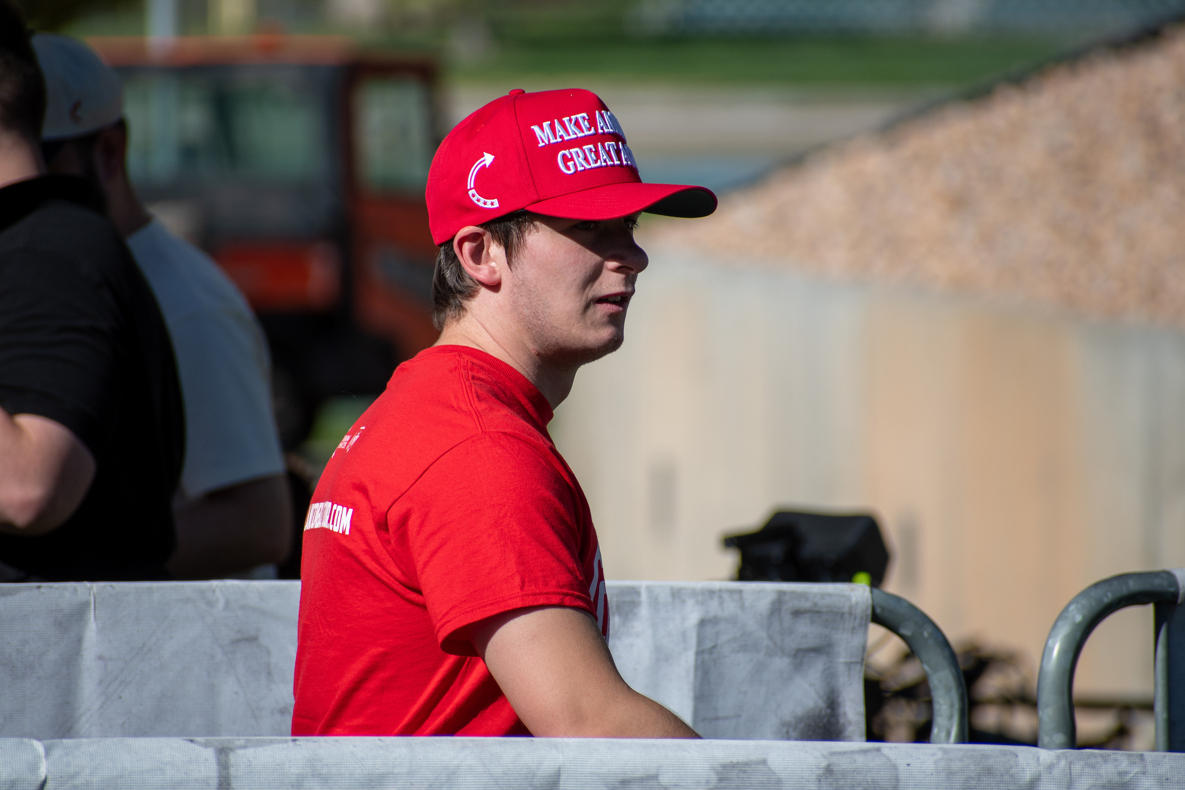 OREM, UTAH – SEPTEMBER 10, 2025: An attendee walks past a metal barrier at Utah Valley University during the opening stop of the American Comeback Tour. Framed mid-stride, the individual reflects a moment of personal movement and quiet presence within the larger gathering. The image captures the rhythm of participation and the emotional texture of a public event. © Charles-McClintock Wilson / ZUMA Press 