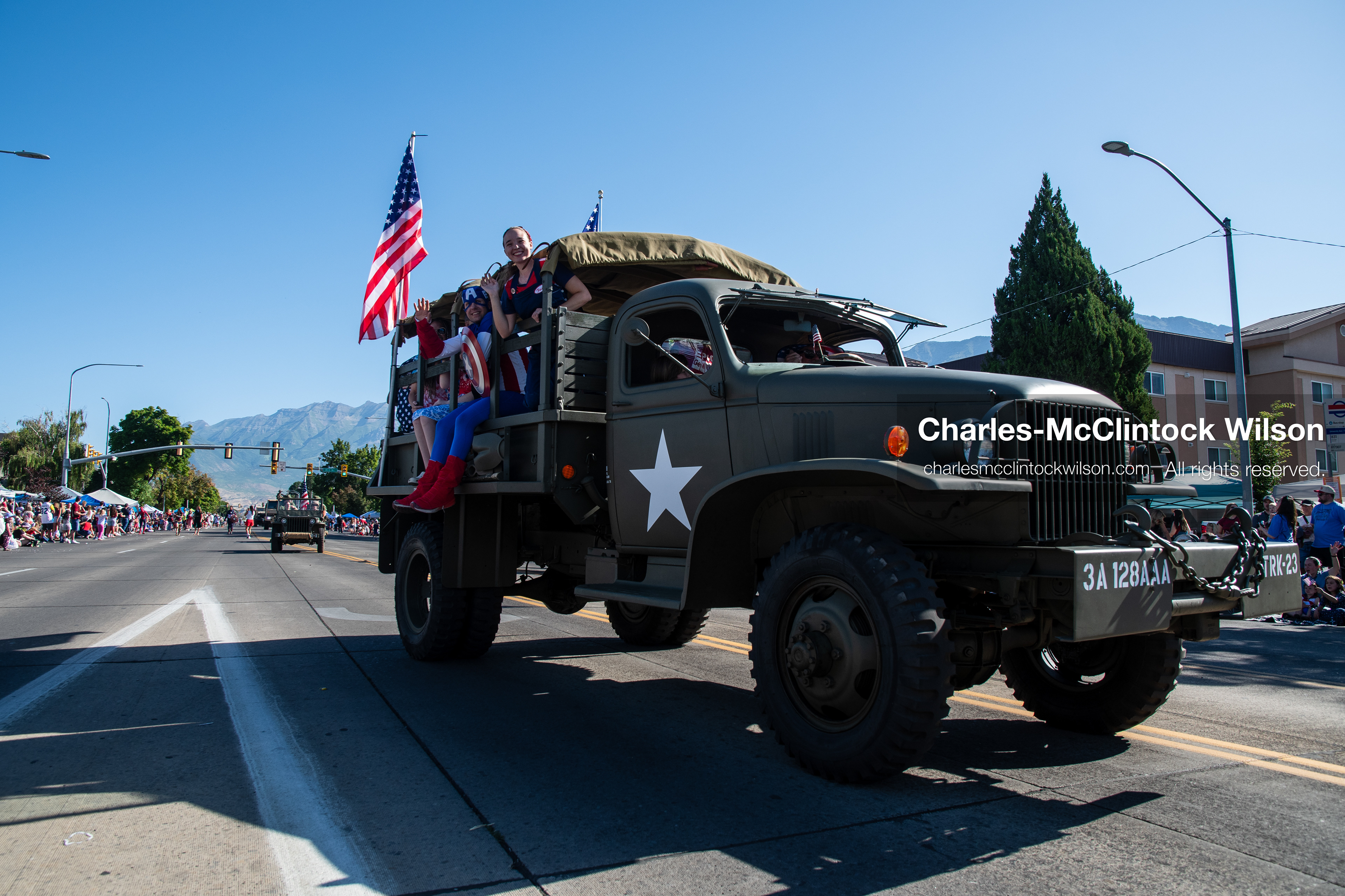 July 4, 2026, Provo, Utah, USA: A vintage military truck carrying passengers and flying American flags drives down the route during America's Freedom Festival Grand Parade in Provo, Utah, Saturday, July 4, 2026. The annual event drew thousands of spectators to the downtown corridor. (Credit Image: © Charles-McClintock Wilson/ZUMA Press Wire)