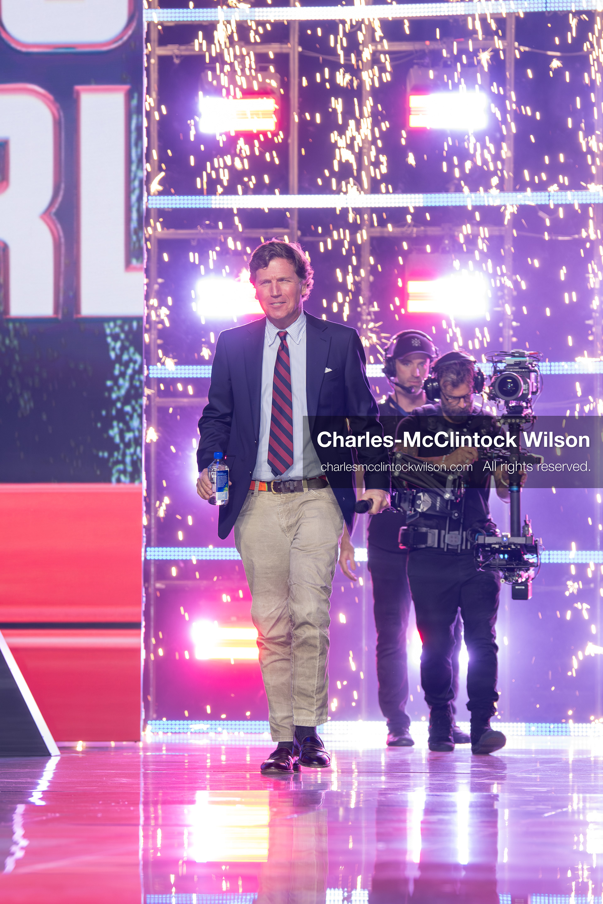 December 18, 2025, Phoenix, Arizona, USA: Tucker Carlson walks toward the stage on Day One of Turning Point USA’s AmericaFest 2025 at the Phoenix Convention Center in Phoenix, Arizona.   (Credit Image: © Charles‑McClintock Wilson/ZUMA Press Wire)