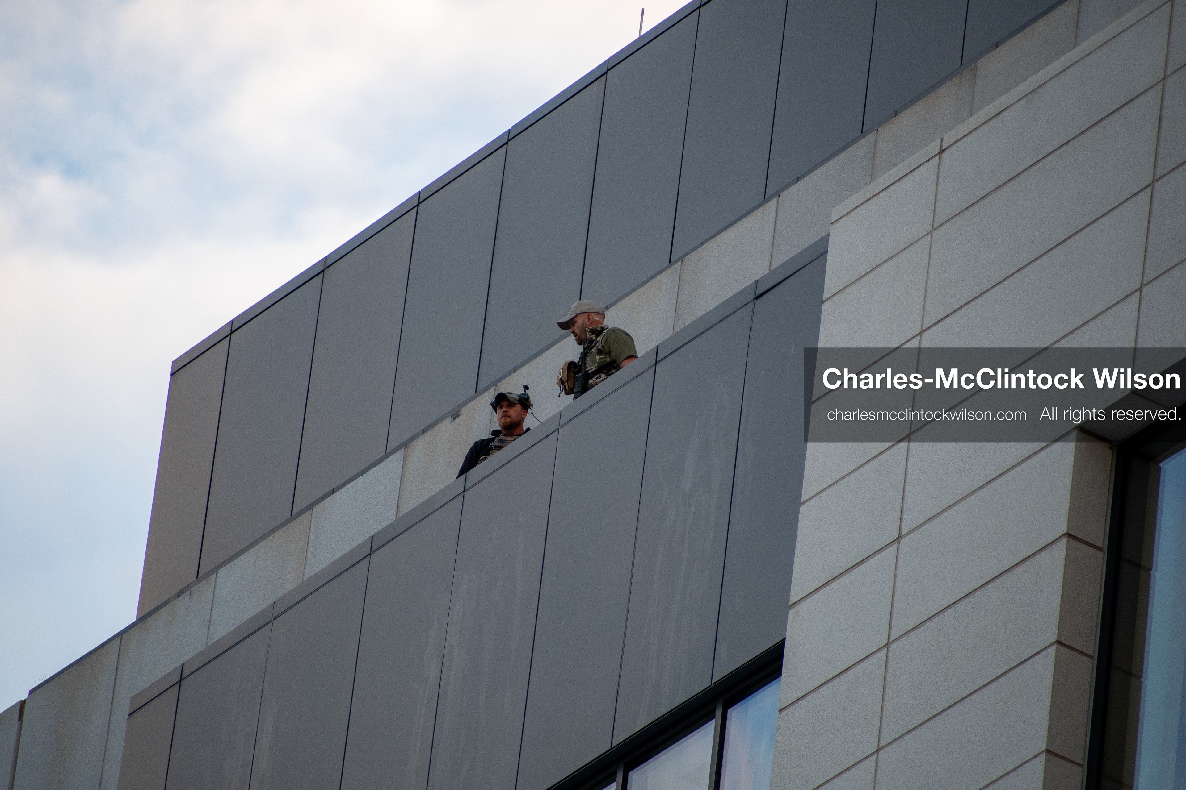 SEPTEMBER 29, 2025 — PROVO, UTAH, USA: Two law enforcement officers stand atop the Utah County Court during a waiver hearing for Tyler Robinson. Robinson, charged with aggravated murder in the September 10 shooting death of conservative activist Charlie Kirk at Utah Valley University, appeared virtually for the proceedings. Officers maintained elevated positions as the hearing unfolded. (Credit Image: © Charles‑McClintock Wilson / ZUMA Press Wire)