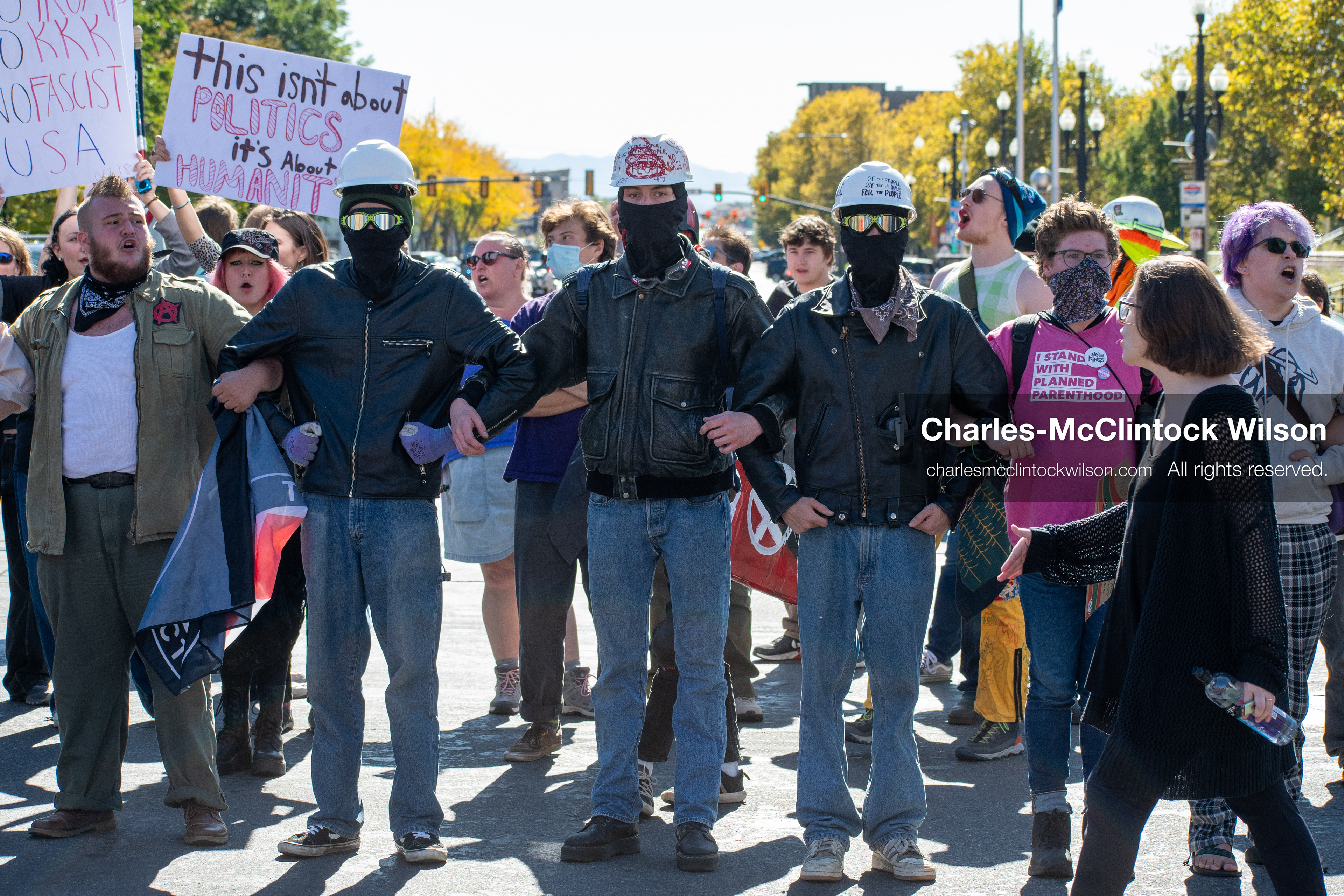 October 18, 2025, Salt Lake City, Utah, USA: Demonstrators link arms during a "No Kings" protest on South State Street in Salt Lake City, Utah. The protest was part of a nationwide mobilization.