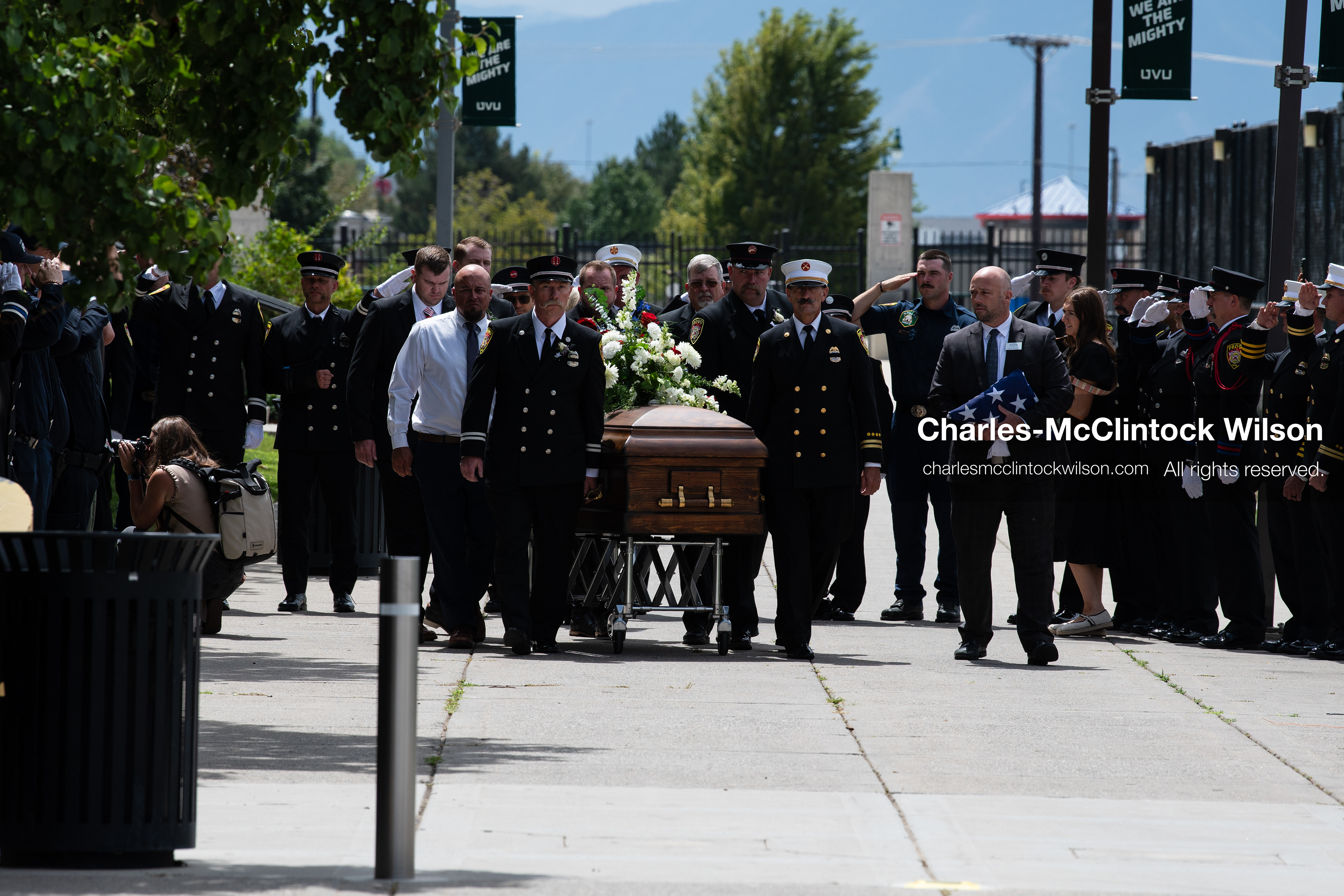 Firefighters and pallbearers escort the casket of Provo Fire Captain Spencer Long outside the UCCU Center on the campus of Utah Valley University in Orem, Utah, on Wednesday, July 29, 2026. More than 300 people came to the public memorial ceremony to honor Captain Long, his wife Katrina, and three of their sons, who died after a flash flood hit their campsite near the Sunglow Campground in Wayne County. (Photo by Charles-McClintock Wilson/Sipa USA)