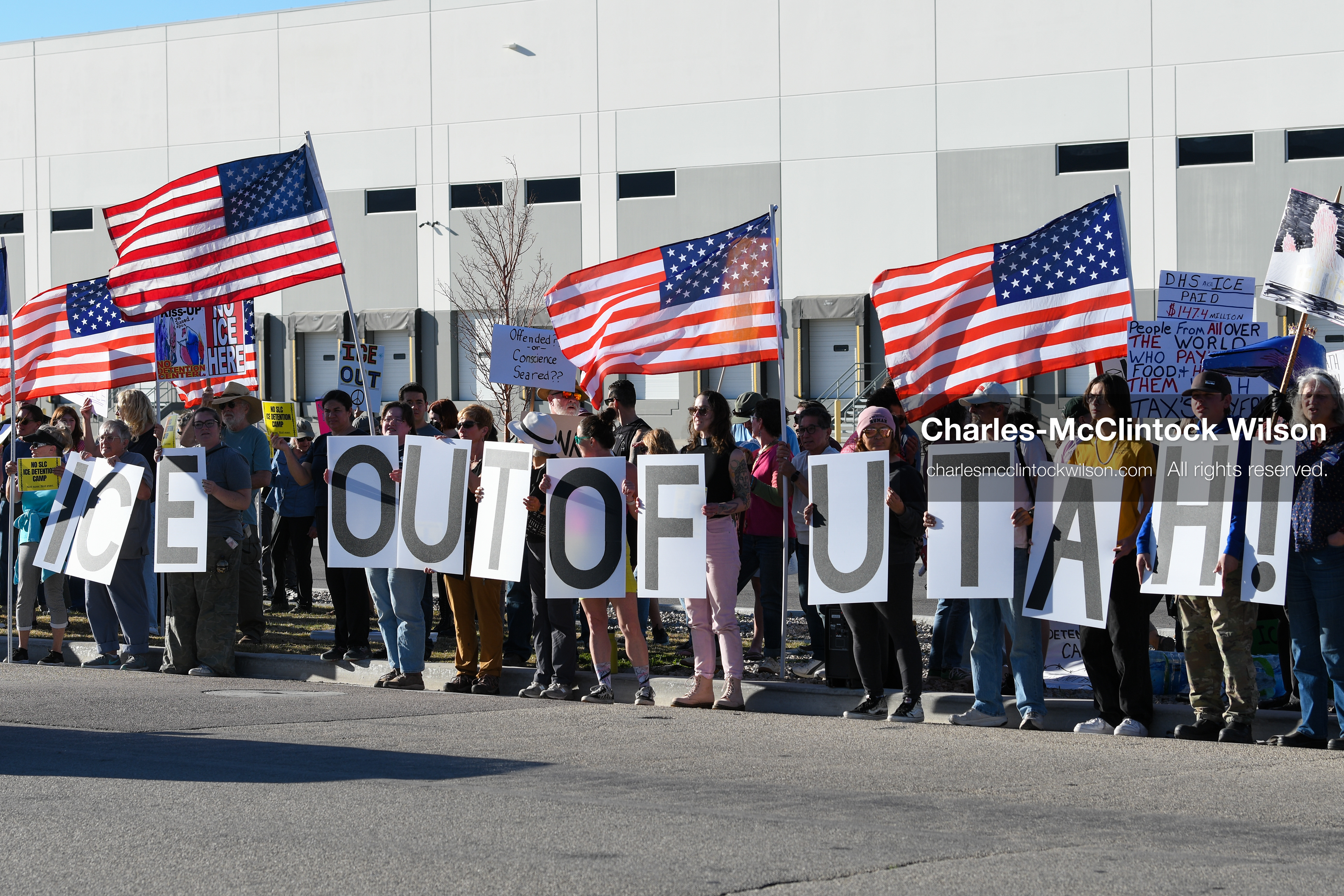 March 18, 2026, Salt Lake City, Utah, USA: People hold signs during a protest at the site of a proposed ICE detention facility on the west side of Salt Lake City. Demonstrators gathered near the warehouse property as part of an ongoing community response to the planned facility. (Credit Image: © Charles McClintock Wilson/ZUMA Press Wire)