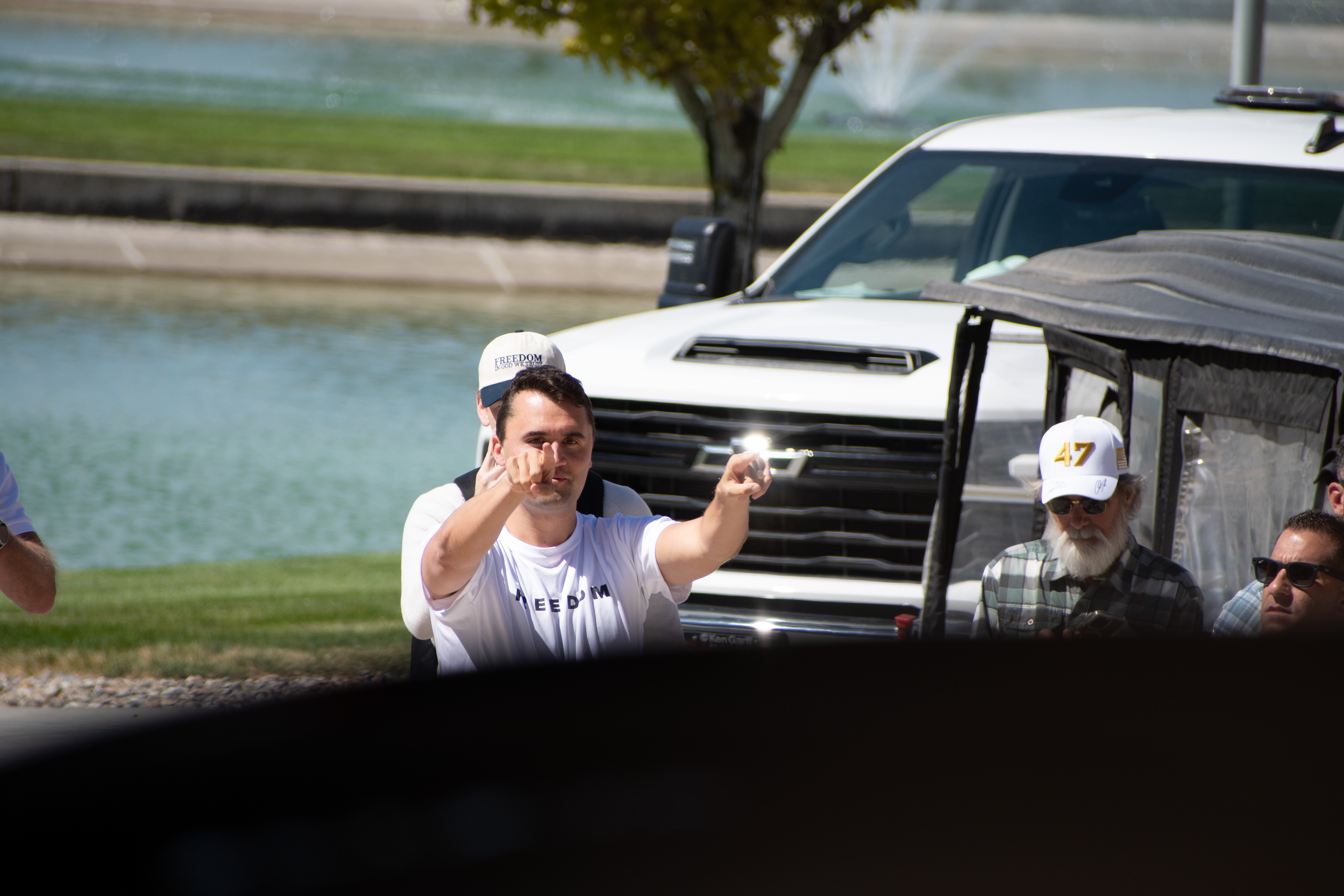 OREM, UTAH – SEPTEMBER 10, 2025: Charlie Kirk gestures while arriving at Utah Valley University for a scheduled public event. Surrounded by supporters and staff near a park-like setting, Kirk points toward the crowd in a moment of expressive engagement. The image marks the beginning of his final public appearance, reflecting anticipation, outreach, and symbolic presence. © Charles-McClintock Wilson / ZUMA Press