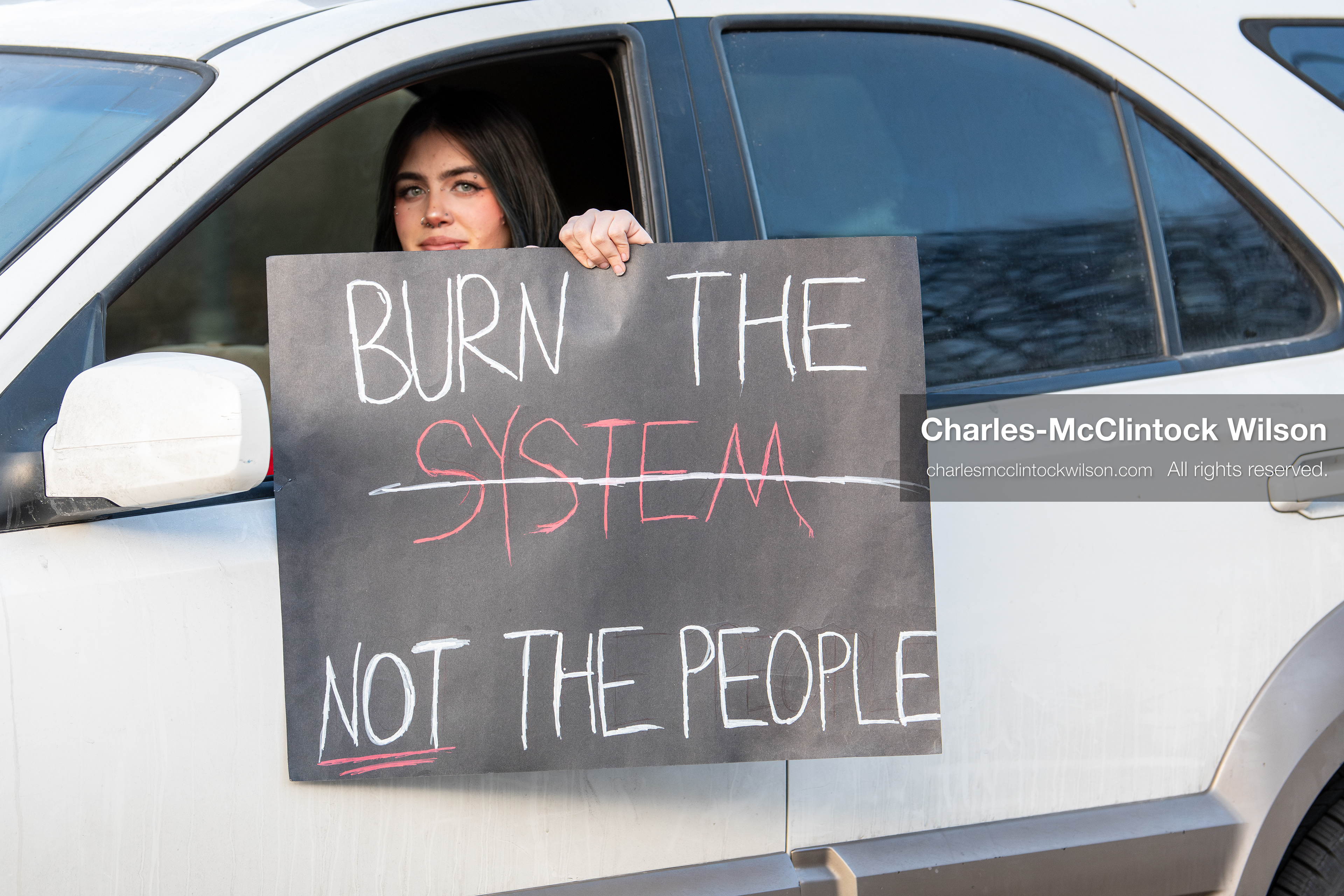 January 30, 2026, Salt Lake City, Utah, USA: A demonstrator displays a protest sign from a vehicle during an anti‑ICE protest in Salt Lake City, part of a nationwide response to immigration enforcement policies. (Credit Image: © Charles‑McClintock Wilson/ZUMA Press Wire)