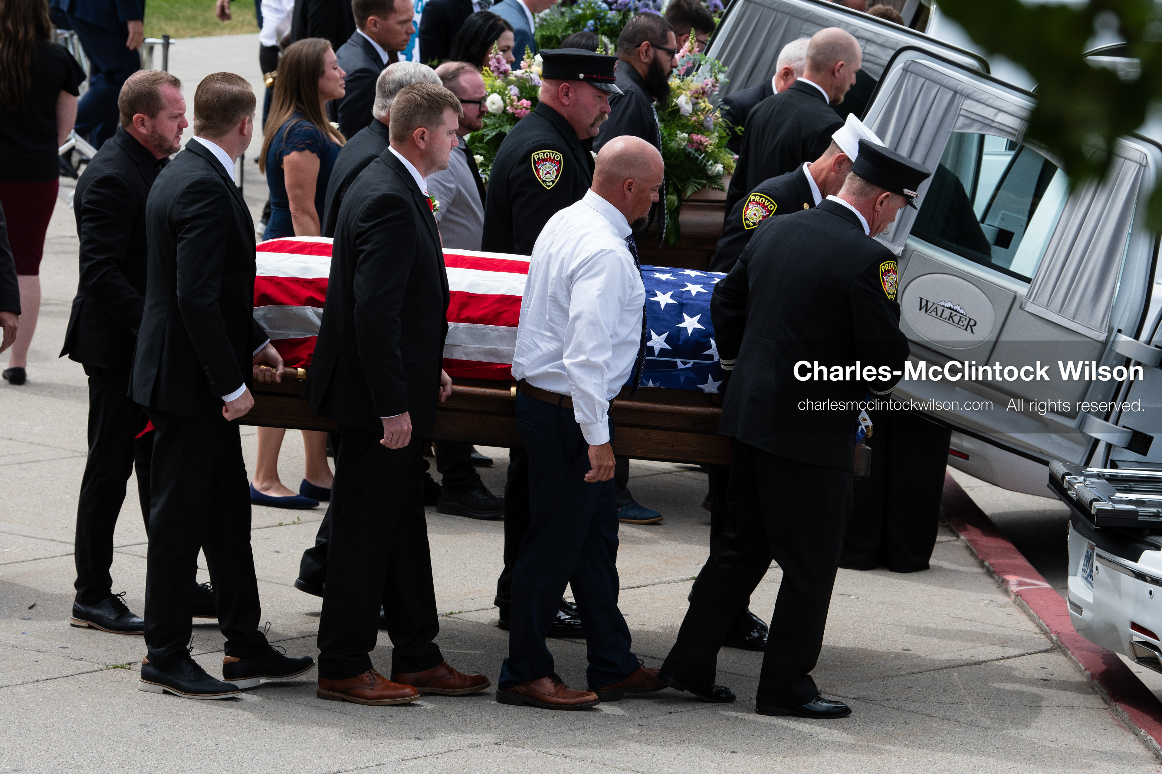 Firefighters and pallbearers load the flag-draped casket of Provo Fire Captain Spencer Long into a white hearse outside the UCCU Center at Utah Valley University in Orem, Utah, on Wednesday, July 29, 2026. More than 300 people came to the public memorial ceremony to honor Captain Long, his wife Katrina, and three of their sons, who died after a flash flood hit their campsite near the Sunglow Campground in Wayne County. (Photo by Charles-McClintock Wilson/Sipa USA)