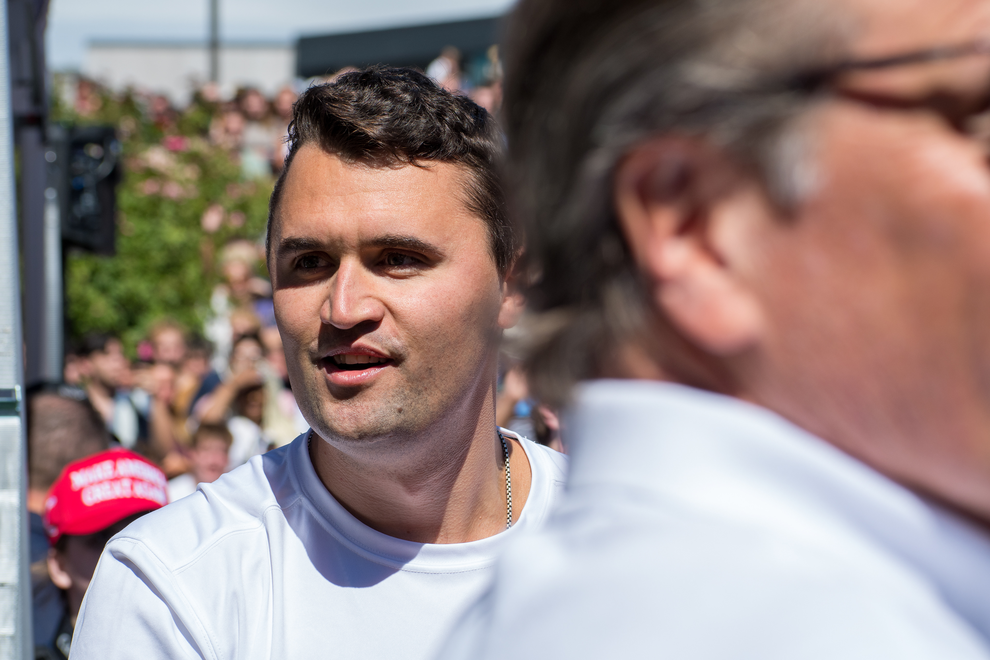 OREM, UTAH – SEPTEMBER 10, 2025: Charlie Kirk speaks with attendees during a public event at Utah Valley University. Positioned near a promotional booth and surrounded by supporters, Kirk appears engaged and expressive in one of his final public moments. The image reflects the atmosphere of direct outreach and energized dialogue that defined the gathering. © Charles-McClintock Wilson / ZUMA Press