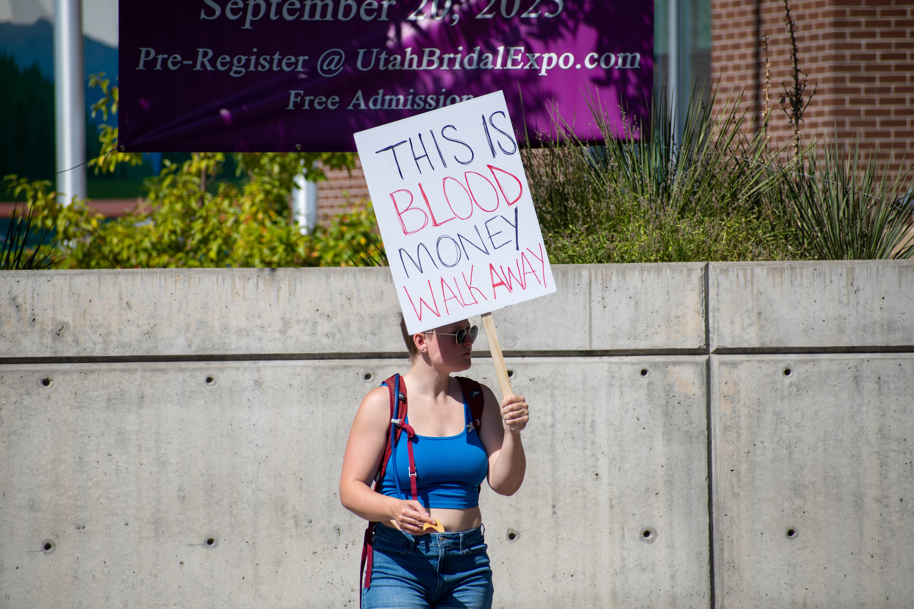 September 15, 2025 – Provo, Utah, United States: A demonstrator holds a sign reading “THIS IS BLOOD MONEY WALK AWAY” outside the Utah Valley Convention Center during a protest against the Department of Homeland Security career expo. The message critiques federal recruitment and calls for moral disengagement. Photograph by Charles‑McClintock Wilson / ZUMA Press Wire
