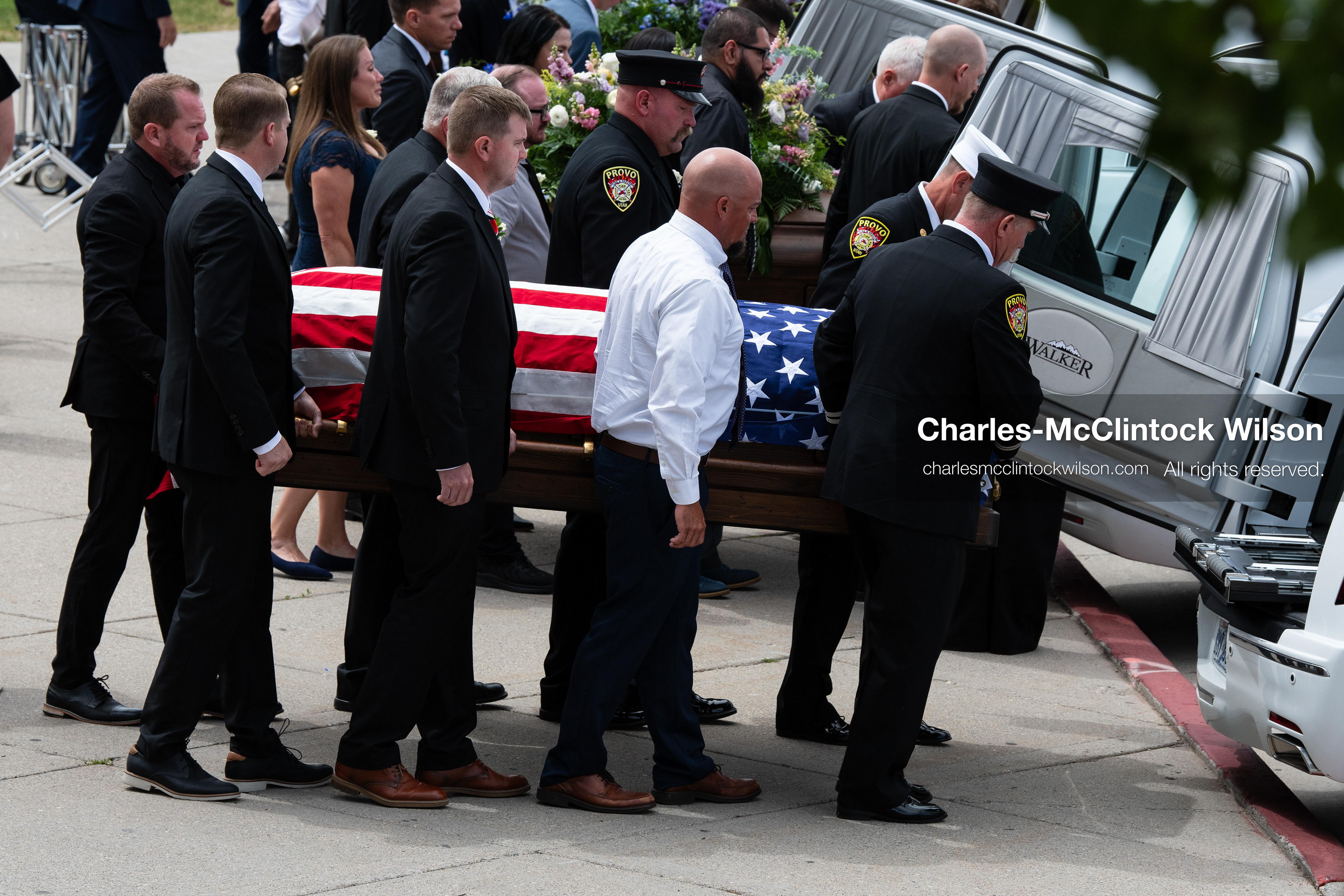 Firefighters and pallbearers load the flag-draped casket of Provo Fire Captain Spencer Long into a white hearse outside the UCCU Center at Utah Valley University in Orem, Utah, on Wednesday, July 29, 2026. More than 300 people came to the public memorial ceremony to honor Captain Long, his wife Katrina, and three of their sons, who died after a flash flood hit their campsite near the Sunglow Campground in Wayne County. (Photo by Charles-McClintock Wilson/Sipa USA)