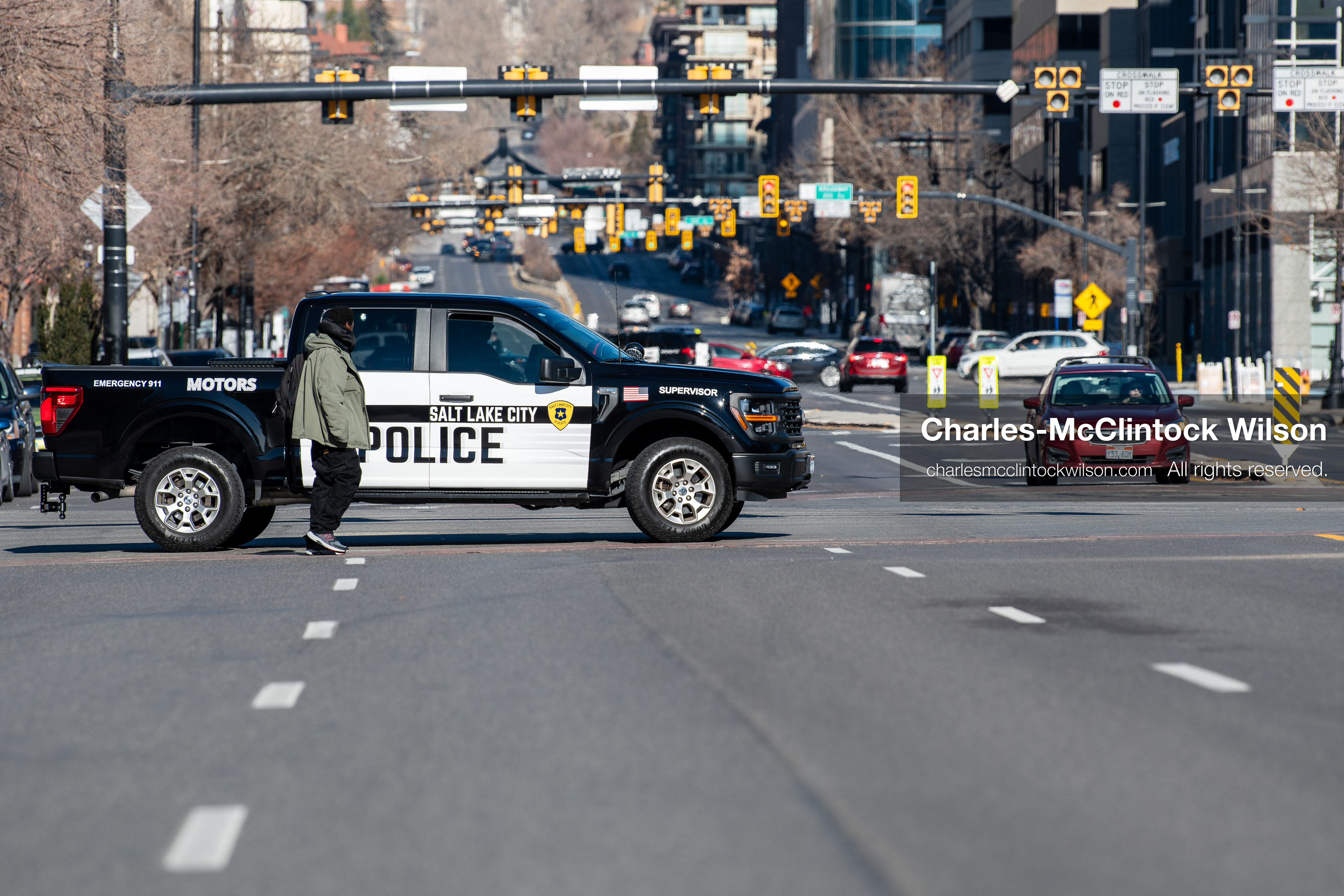 Salt Lake City, Utah, January 10, 2026: A Salt Lake City Police Department vehicle blocks Main Street near Washington Square Park as a pedestrian walks past during the ICE Out for Good protest, a demonstration calling for justice for Renee Nicole Good. (Credit Image: © Charles‑McClintock Wilson/ZUMA Press Wire)