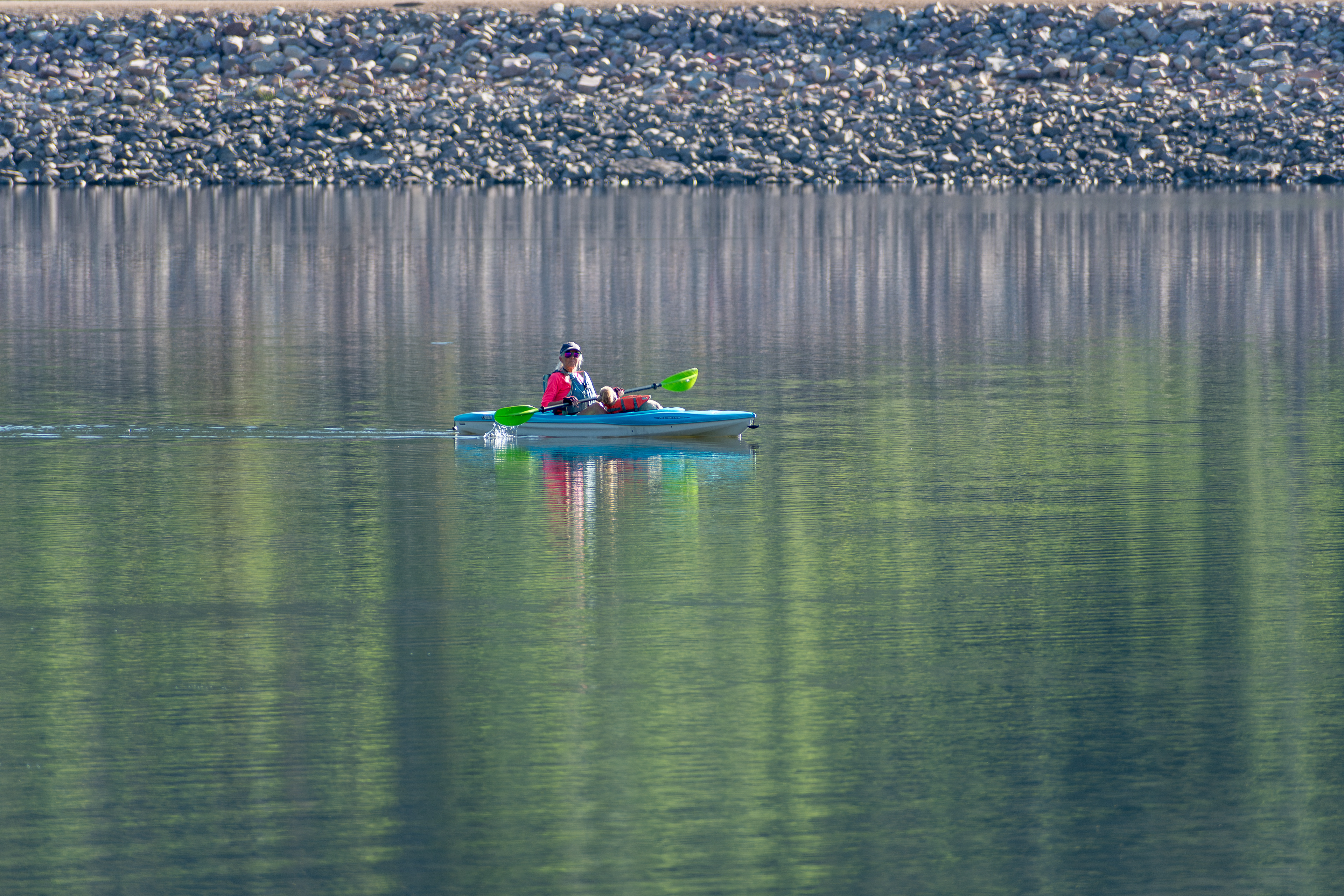 Summit County, Utah – July 20, 2025: A woman paddles a kayak across the calm waters of Smith and Morehouse Reservoir during a peaceful summer outing.