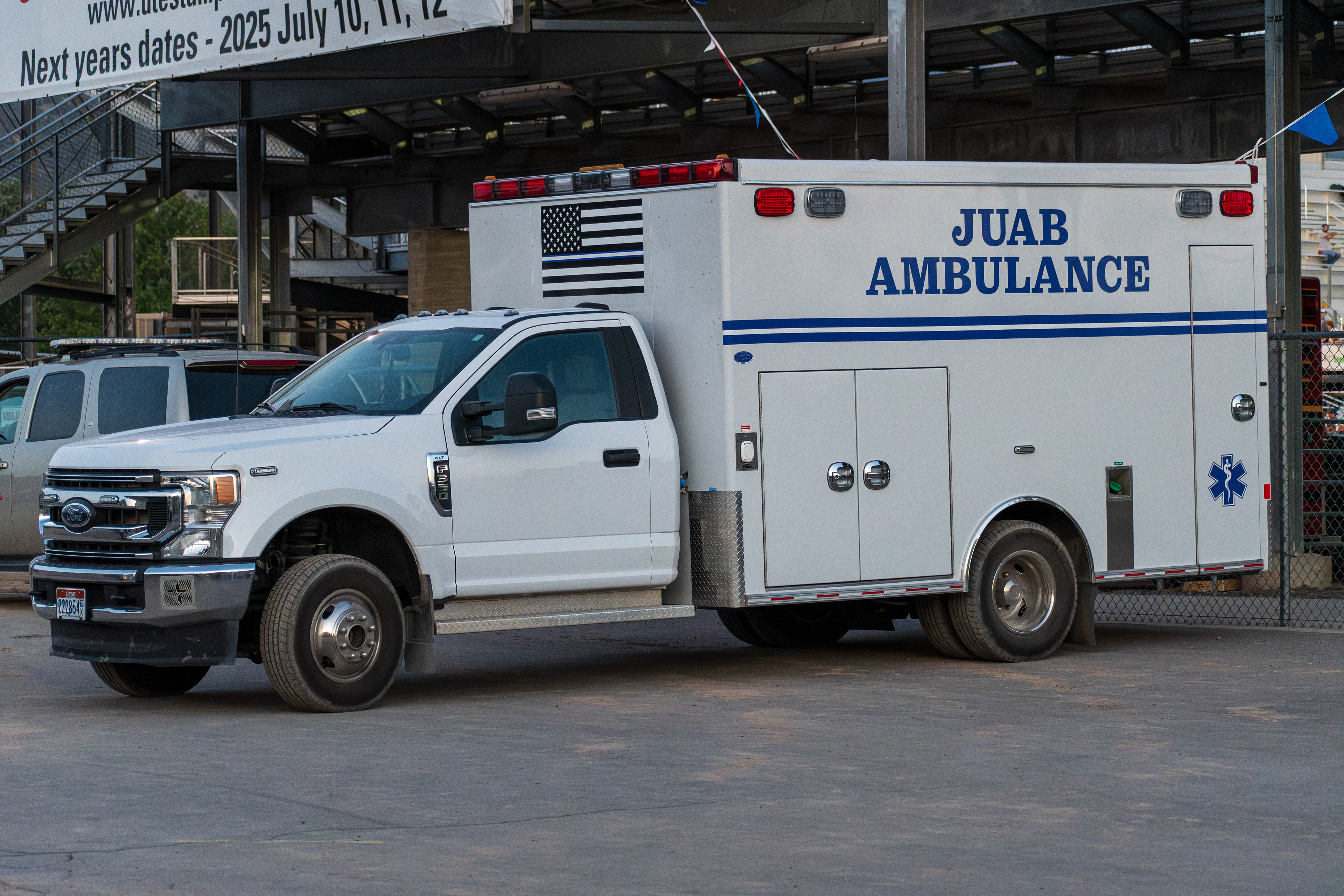 Nephi, Utah – June 28, 2025: A Juab County ambulance is parked outside the Juab County Fairgrounds during the Juab Xtreme Racing event. The vehicle, marked with a subdued American flag and emergency medical insignia, stands ready to support local EMS response during the high-adrenaline motocross competition.