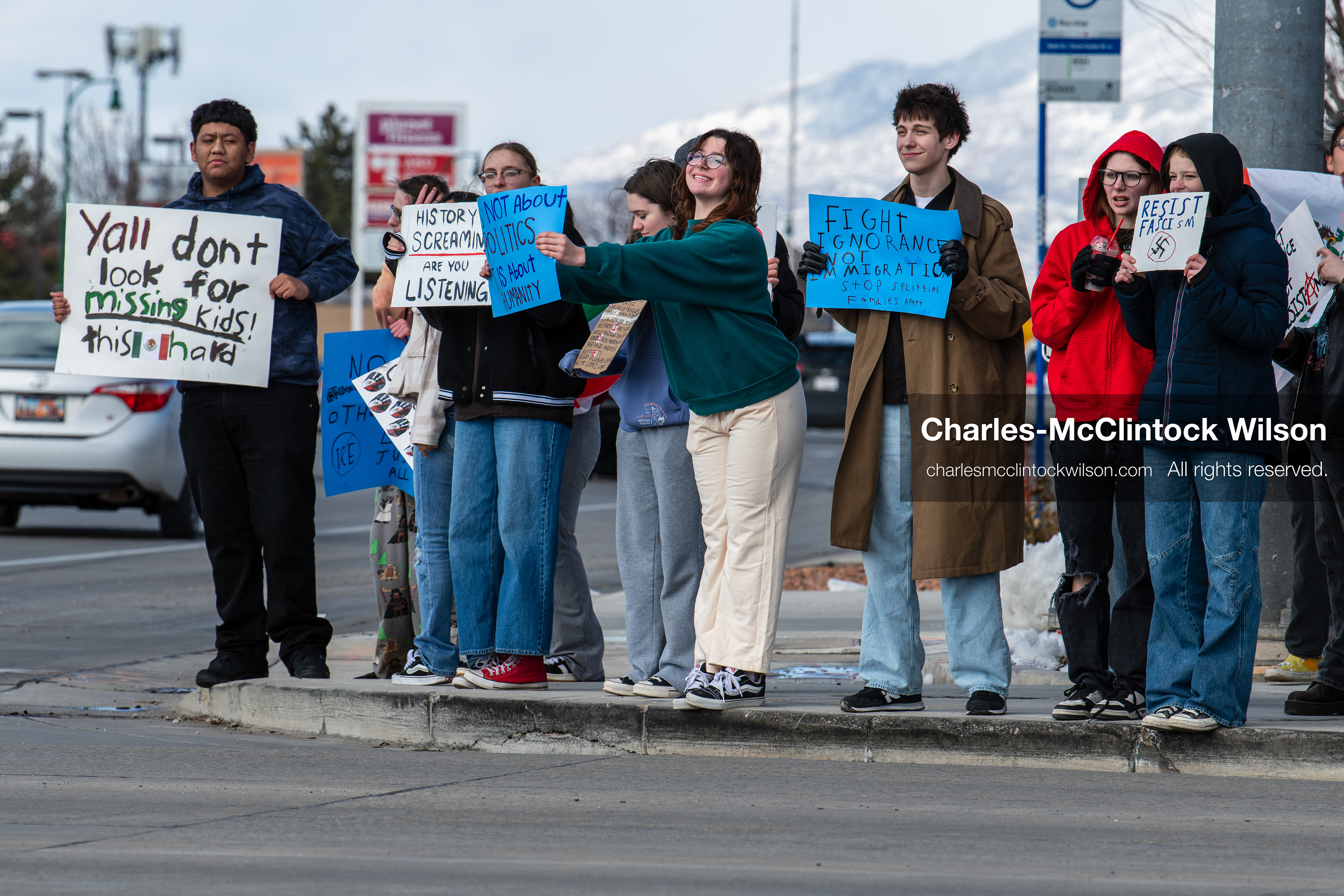 February 20, 2026, Orem, Utah, USA: High school students gather along State Street in front of Orem City Hall during a student led protest against ICE and federal immigration enforcement. Demonstrators hold signs as they stand near the roadway while traffic continues through the area. (Credit Image: © Charles McClintock Wilson/ZUMA Press Wire)