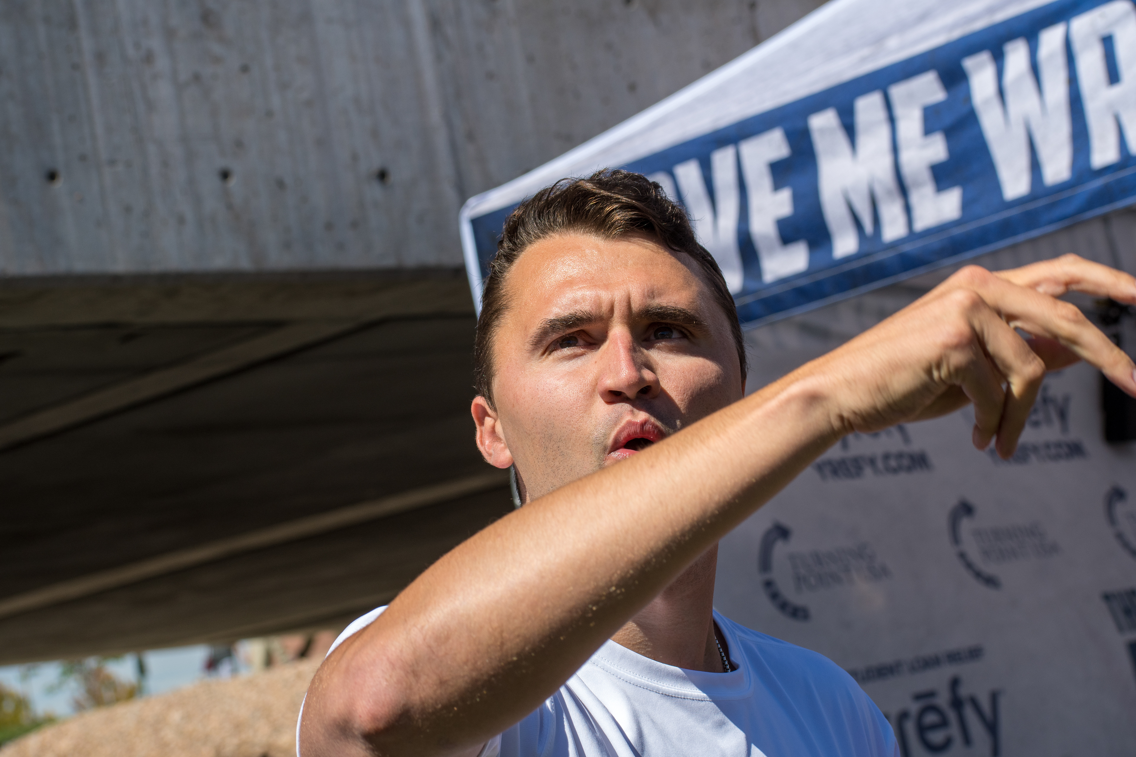OREM, UTAH – SEPTEMBER 10, 2025: Charlie Kirk speaks with attendees during a public event at Utah Valley University. Positioned near a promotional booth and surrounded by supporters, Kirk appears engaged and expressive in one of his final public moments. The image reflects the atmosphere of direct outreach and energized dialogue that defined the gathering. © Charles-McClintock Wilson / ZUMA Press