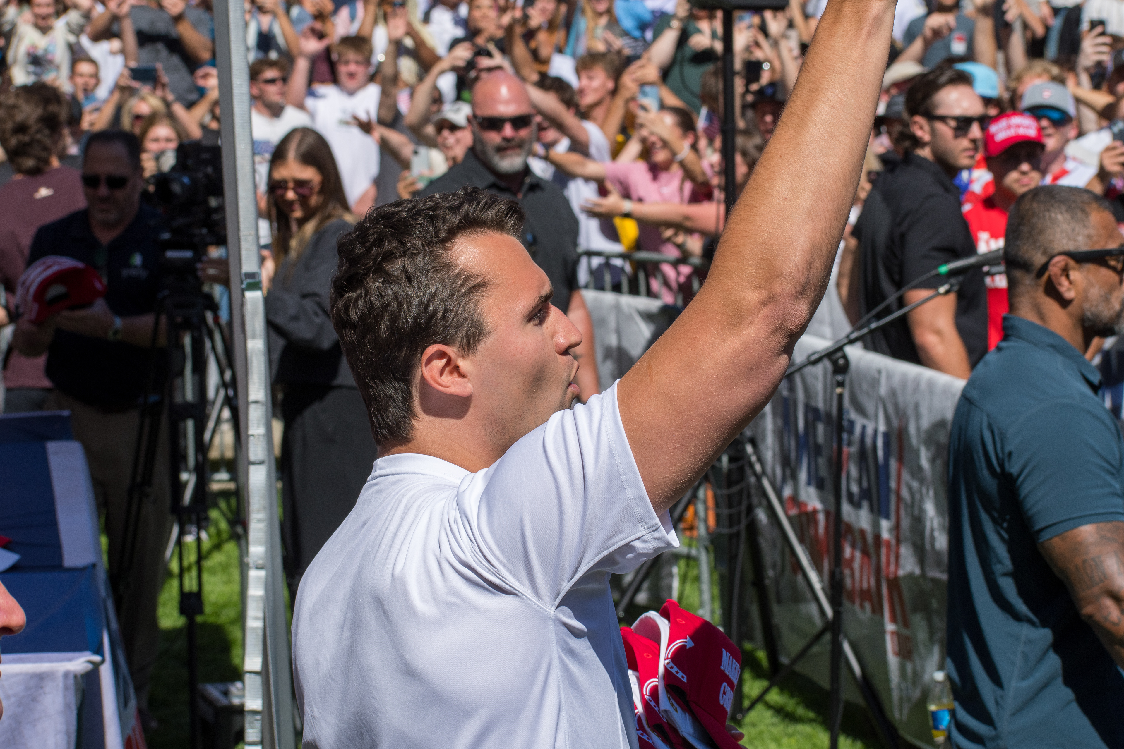  OREM, UTAH – SEPTEMBER 10, 2025: Charlie Kirk holds several “Make America Great Again” hats while interacting with supporters during a public event at Utah Valley University. Positioned near a merchandise table and surrounded by attendees, Kirk engages directly with the crowd in one of his final public moments. The image reflects the branding, outreach, and political symbolism that defined the gathering. © Charles-McClintock Wilson / ZUMA Press