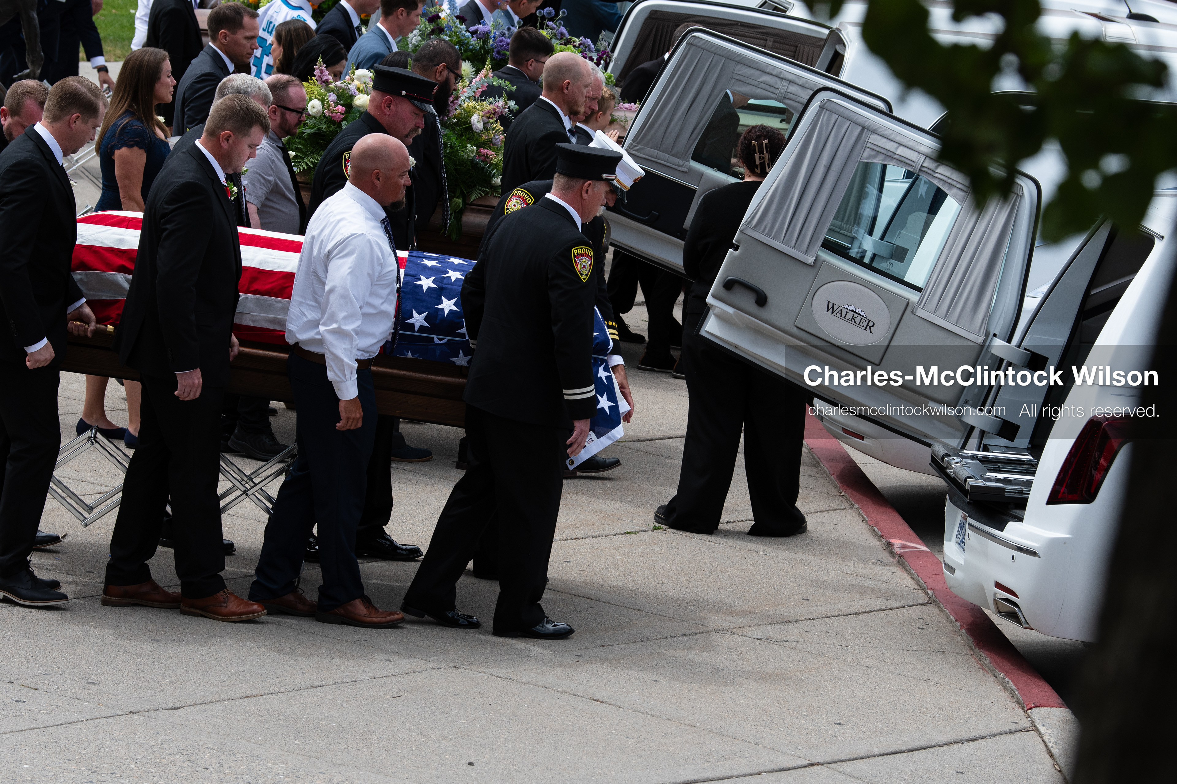 Firefighters and pallbearers load the flag-draped casket of Provo Fire Captain Spencer Long into a white hearse outside the UCCU Center at Utah Valley University in Orem, Utah, on Wednesday, July 29, 2026. More than 300 people came to the public memorial ceremony to honor Captain Long, his wife Katrina, and three of their sons, who died after a flash flood hit their campsite near the Sunglow Campground in Wayne County. (Photo by Charles-McClintock Wilson/Sipa USA)