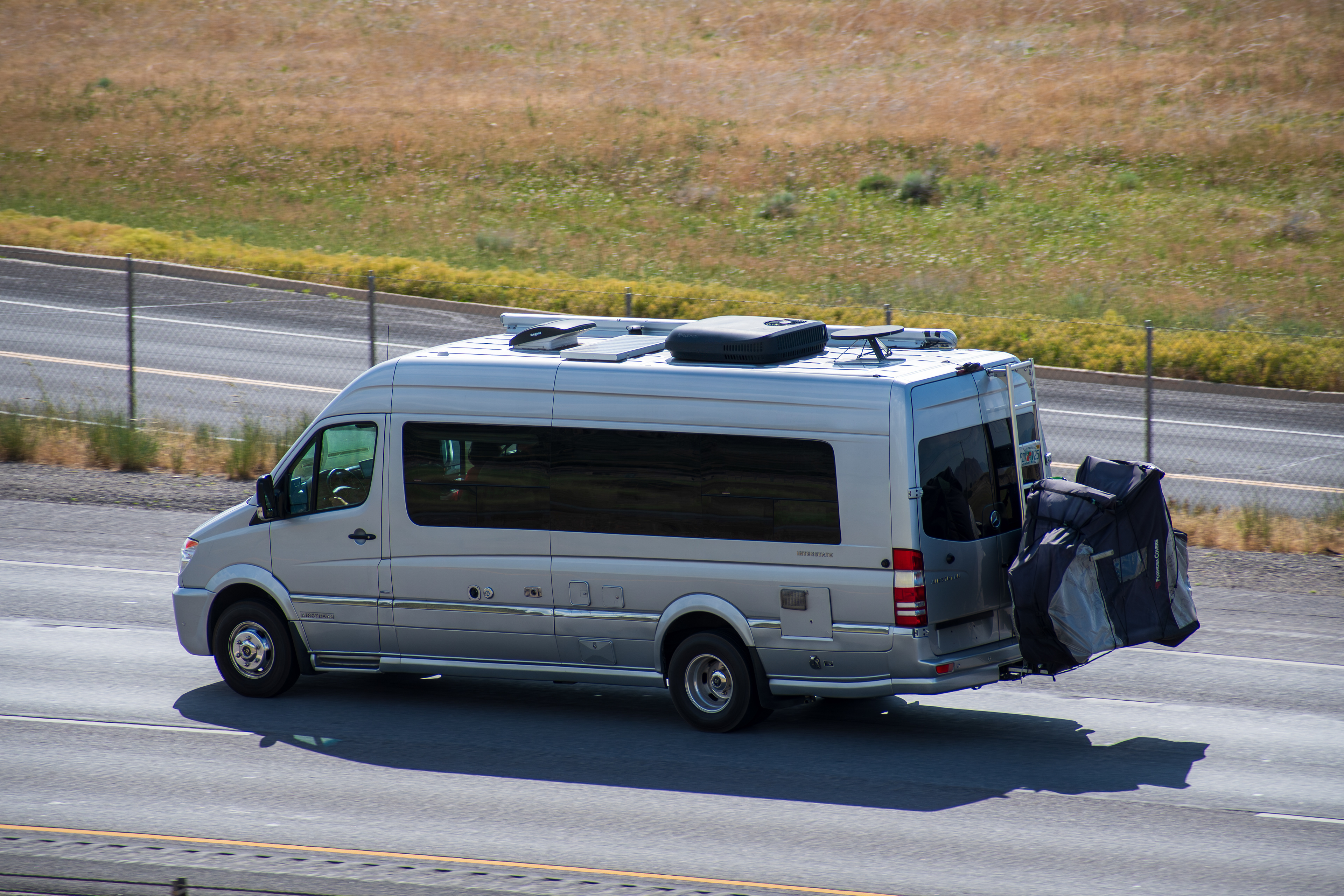 SANTAQUIN, UT – JUNE 8, 2025: A camper van travels north on Interstate 15 near Santaquin, Utah. The summer season draws camper vans and travelers through the state, known for its national parks.