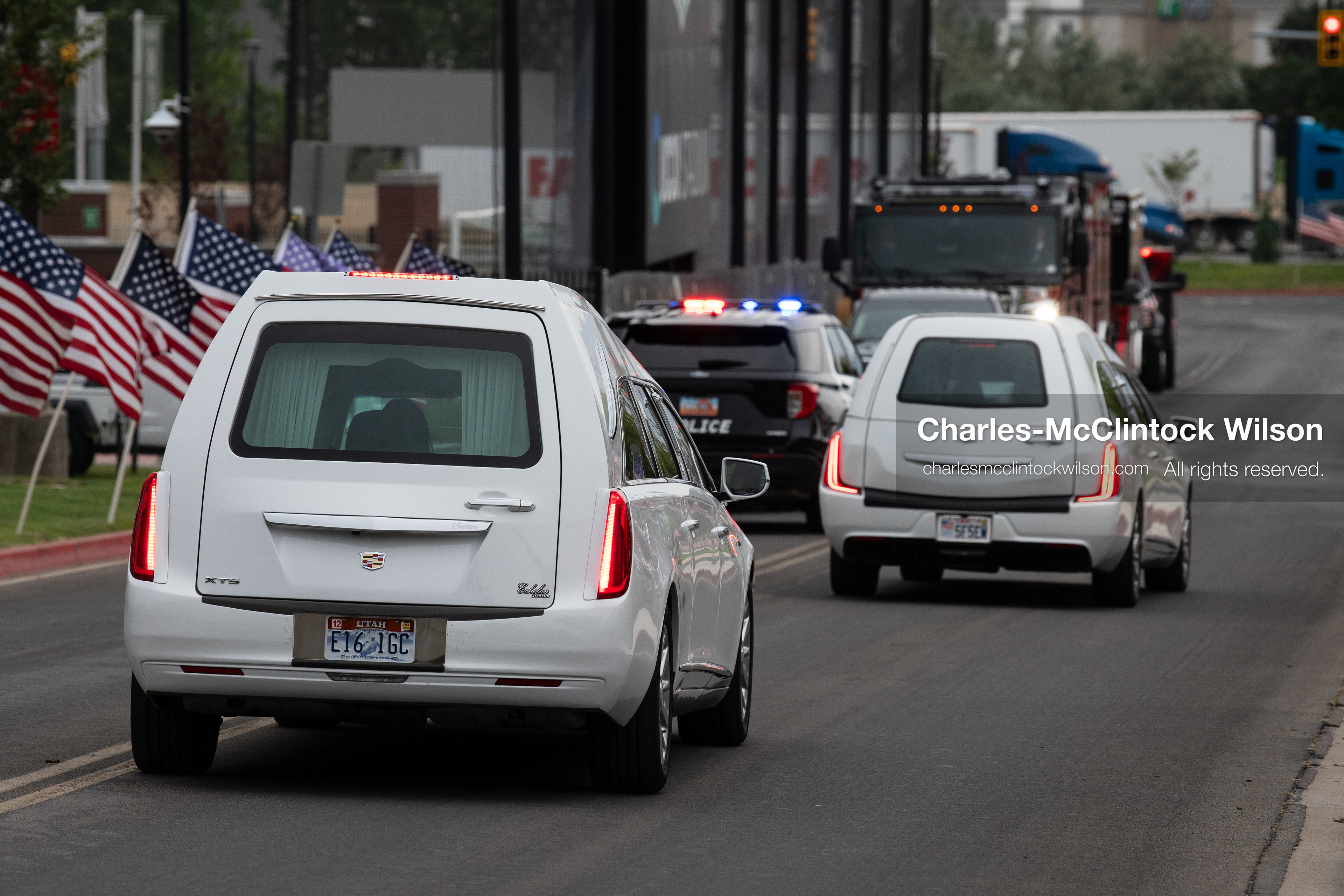 A motorcade of white Cadillac hearses drives along a roadway outside the UCCU Center at Utah Valley University in Orem, Utah, on Wednesday, July 29, 2026. More than 300 people came to the public memorial ceremony to honor Provo Fire Captain Spencer Long, his wife Katrina, and three of their sons, who died after a flash flood hit their campsite near the Sunglow Campground in Wayne County. (Photo by Charles-McClintock Wilson/Sipa USA)