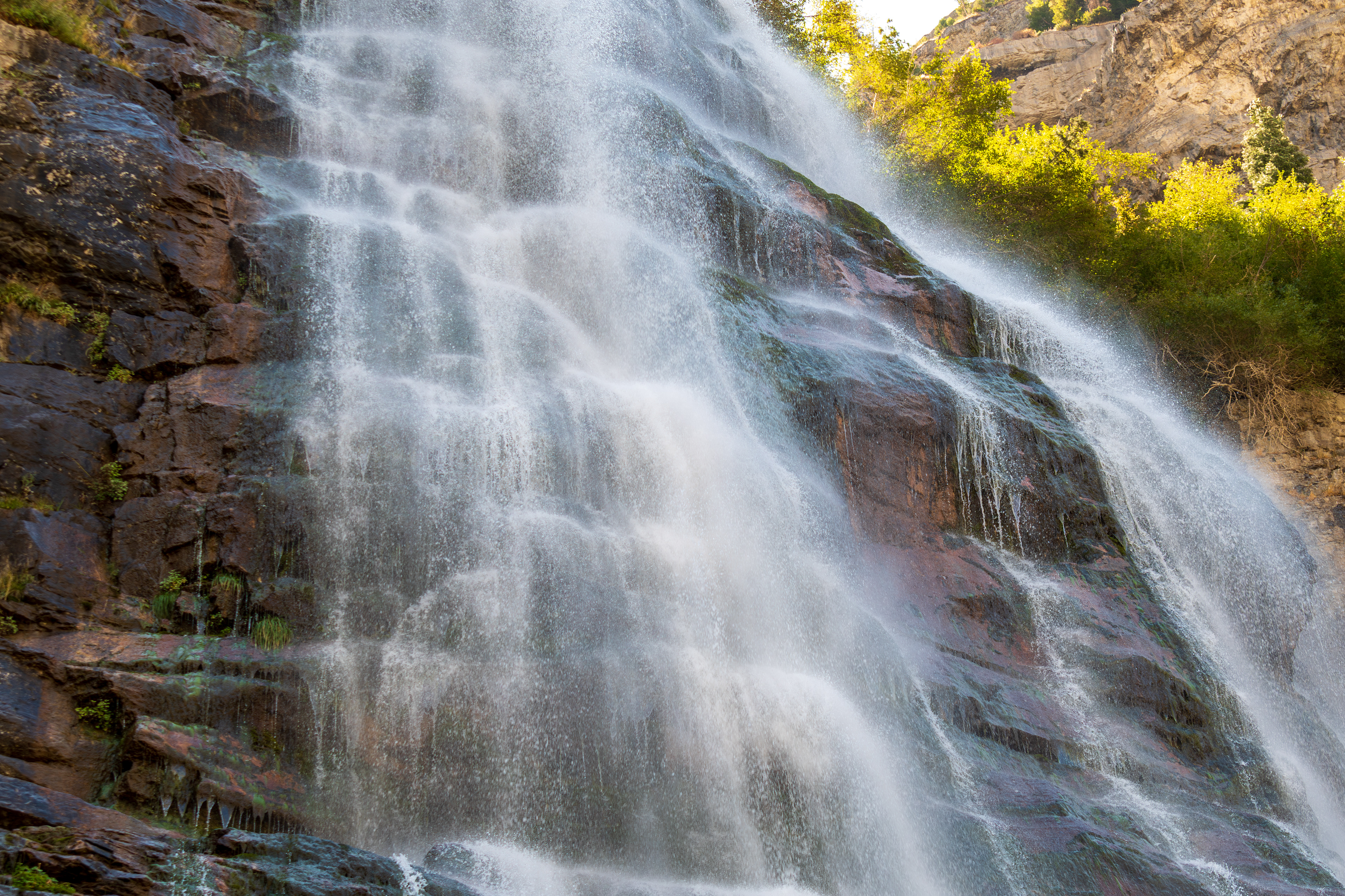 Provo, Utah, USA — September 1, 2025: Bridal Veil Falls cascades down rugged cliffs in a vertical display of height and motion, framed by sparse greenery and exposed rock, in Provo Canyon, Utah. 
