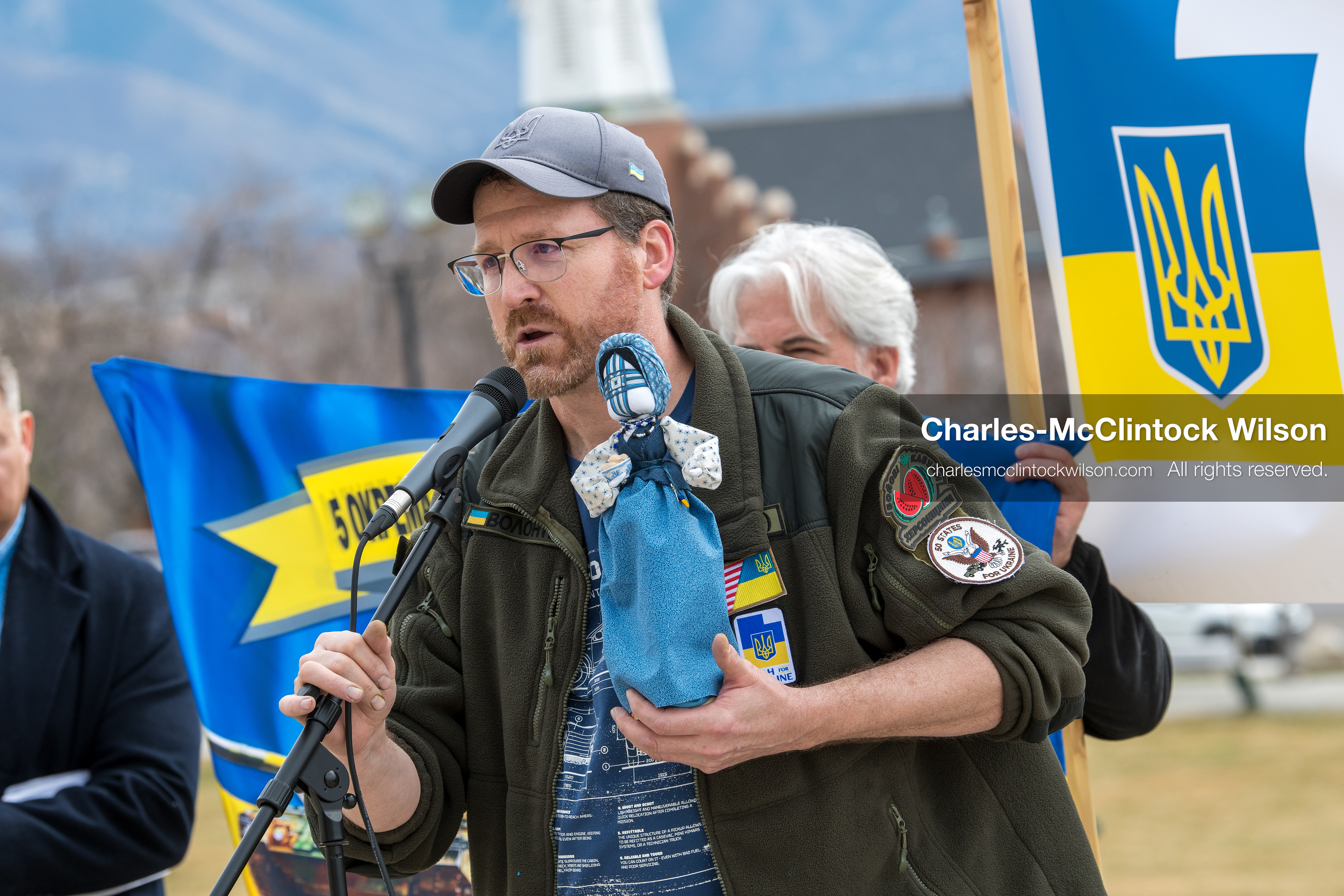 February 28, 2026, Salt Lake City, Utah, USA: NATHANIEL SANDERS, a Salt Lake County Deputy District Attorney and a vocal advocate for Ukraine, speaks while holding a traditional Ukrainian motanka doll, a handmade protective symbol, during the Stand With Ukraine rally at the Utah State Capitol. The event marked the four year anniversary of the full scale Russian invasion of Ukraine and brought community members together in support of Ukrainians and local humanitarian efforts. (Credit Image: © Charles McClintock Wilson/ZUMA Press Wire)
