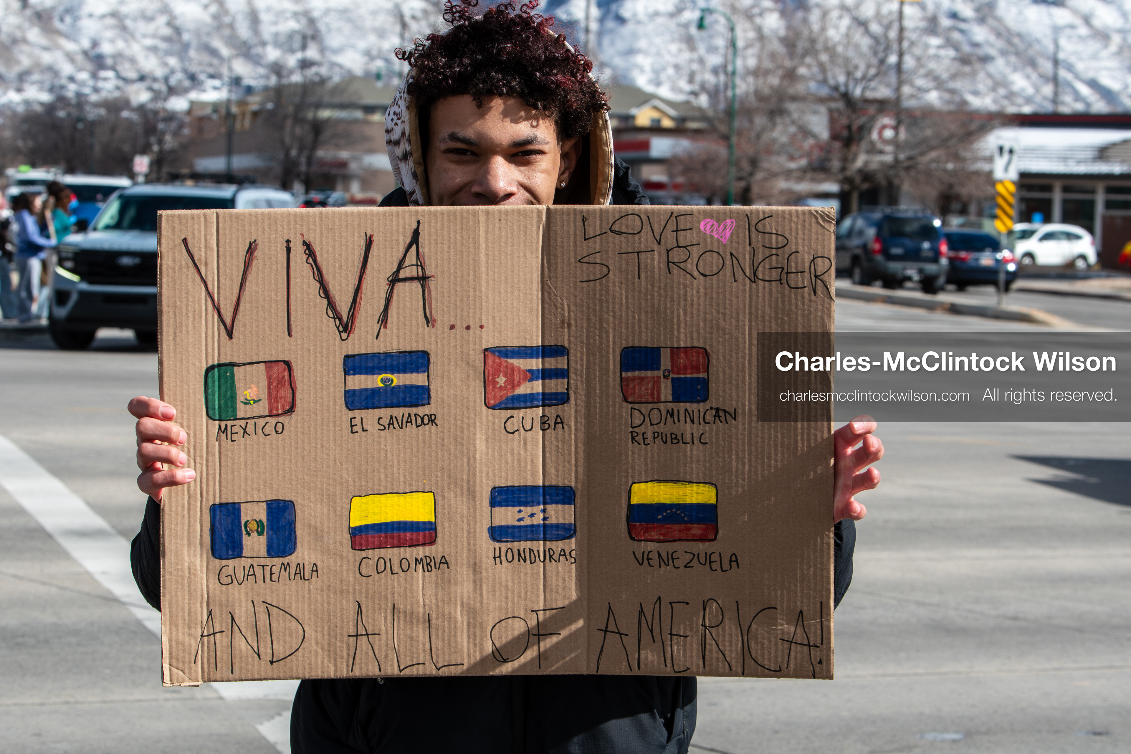 February 20, 2026, Orem, Utah, USA: A participant holds a sign displaying multiple Latin American flags during a student led protest against ICE in front of Orem City Hall. Demonstrators gathered along State Street as traffic moved through the area. (Credit Image: © Charles McClintock Wilson/ZUMA Press Wire)