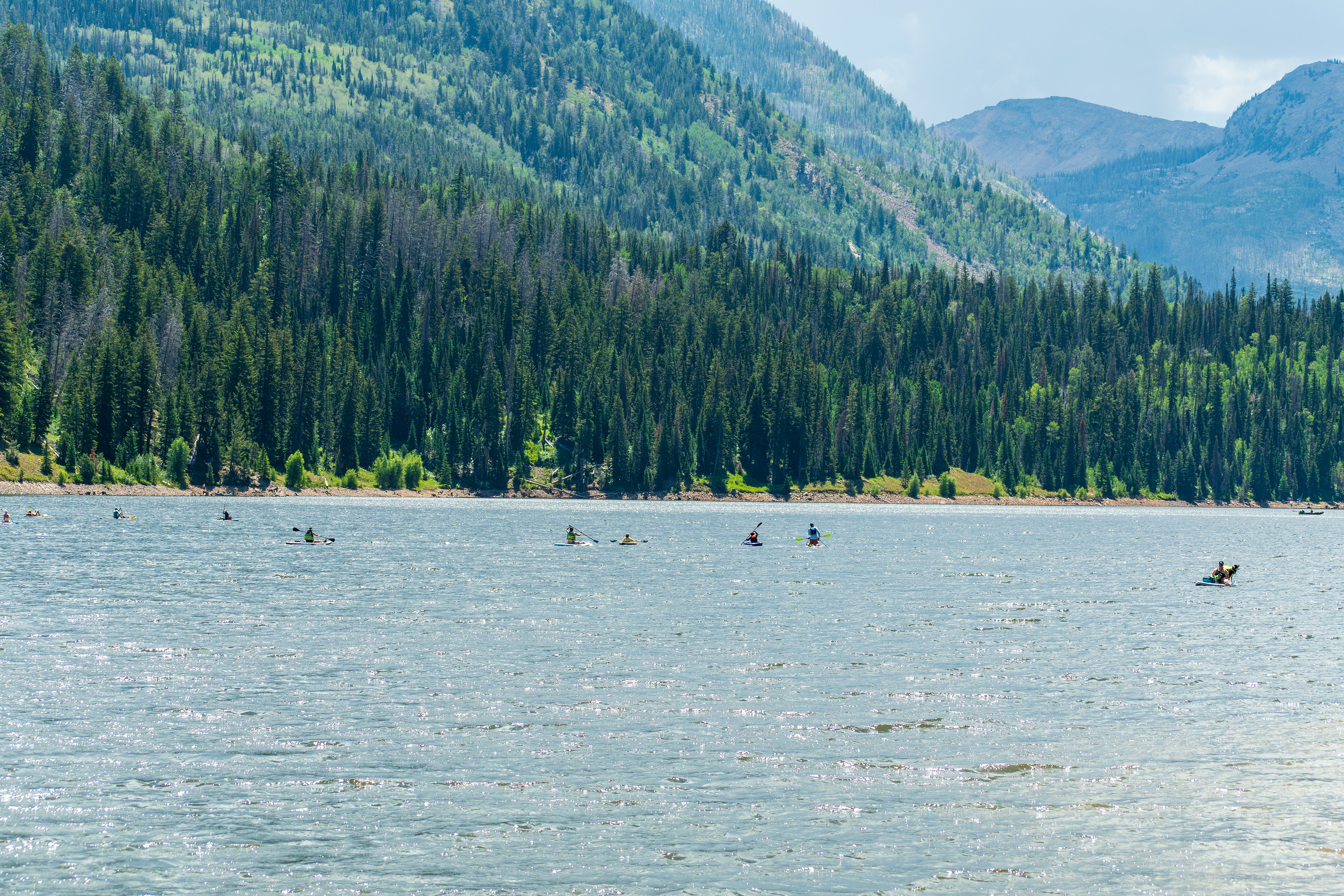Summit County, Utah – July 20, 2025: People enjoy outdoor recreation on kayaks and paddleboards at Smith and Morehouse Reservoir.