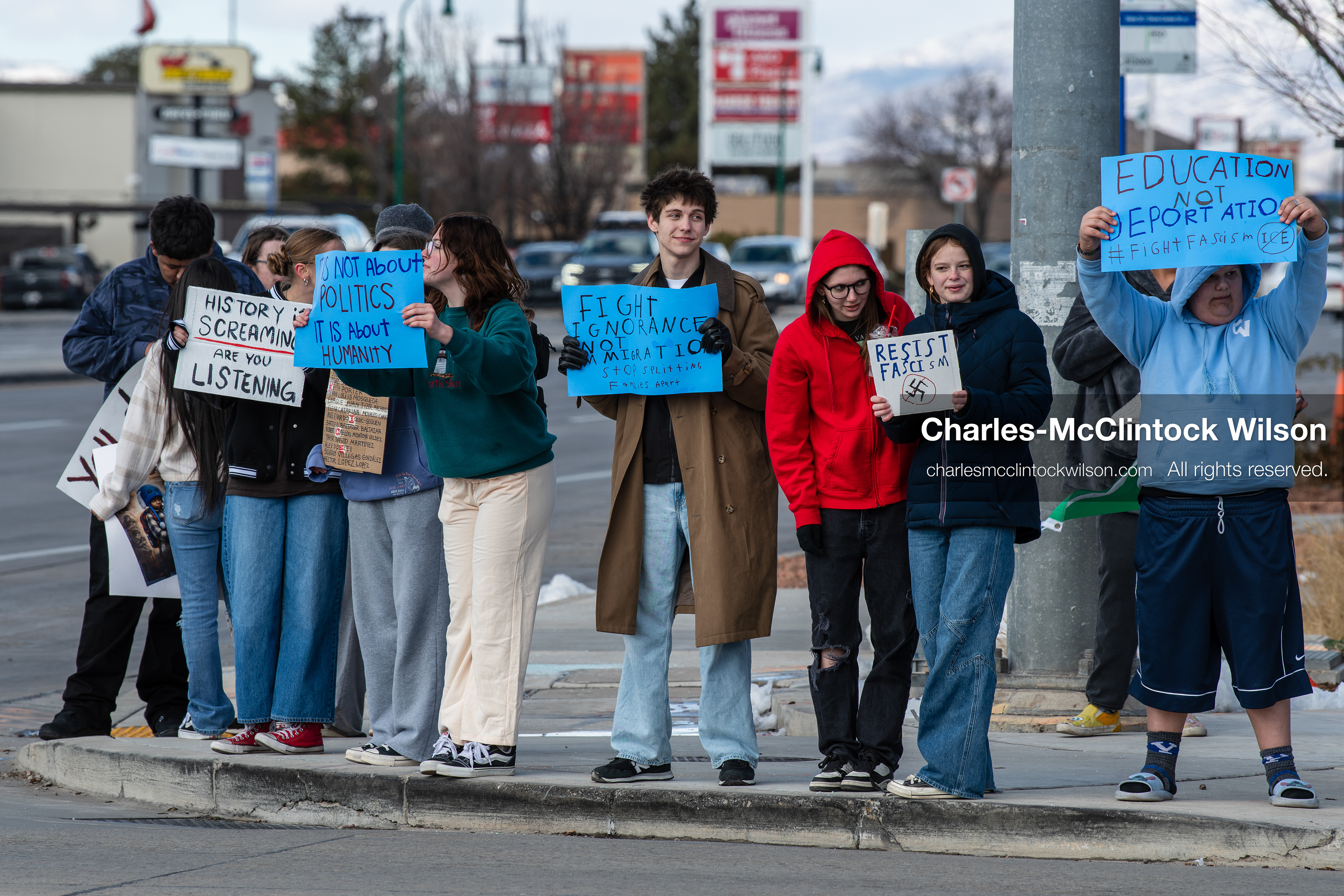 February 20, 2026, Orem, Utah, USA: High school students gather along State Street in front of Orem City Hall during a student led protest against ICE and federal immigration enforcement. Demonstrators hold signs as they stand near the roadway while traffic continues through the area. (Credit Image: © Charles McClintock Wilson/ZUMA Press Wire)