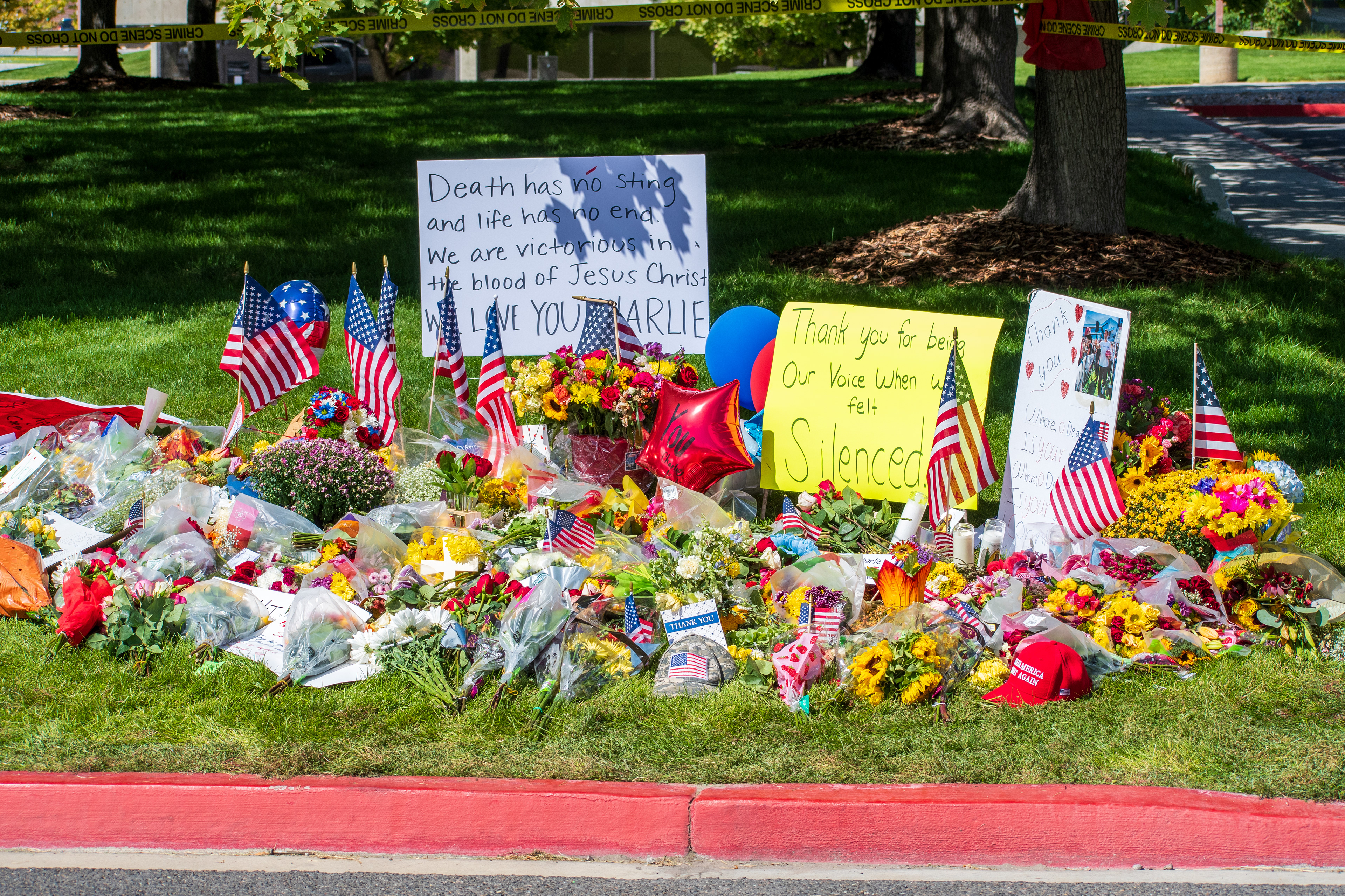 OREM, UTAH – SEPTEMBER 12, 2025: Flowers, American flags, balloons, and handwritten posters are arranged on a grassy memorial site for Charlie Kirk near Utah Valley University. The tribute reflects a collective expression of remembrance and community solidarity. © Charles‑McClintock Wilson / ZUMA Press