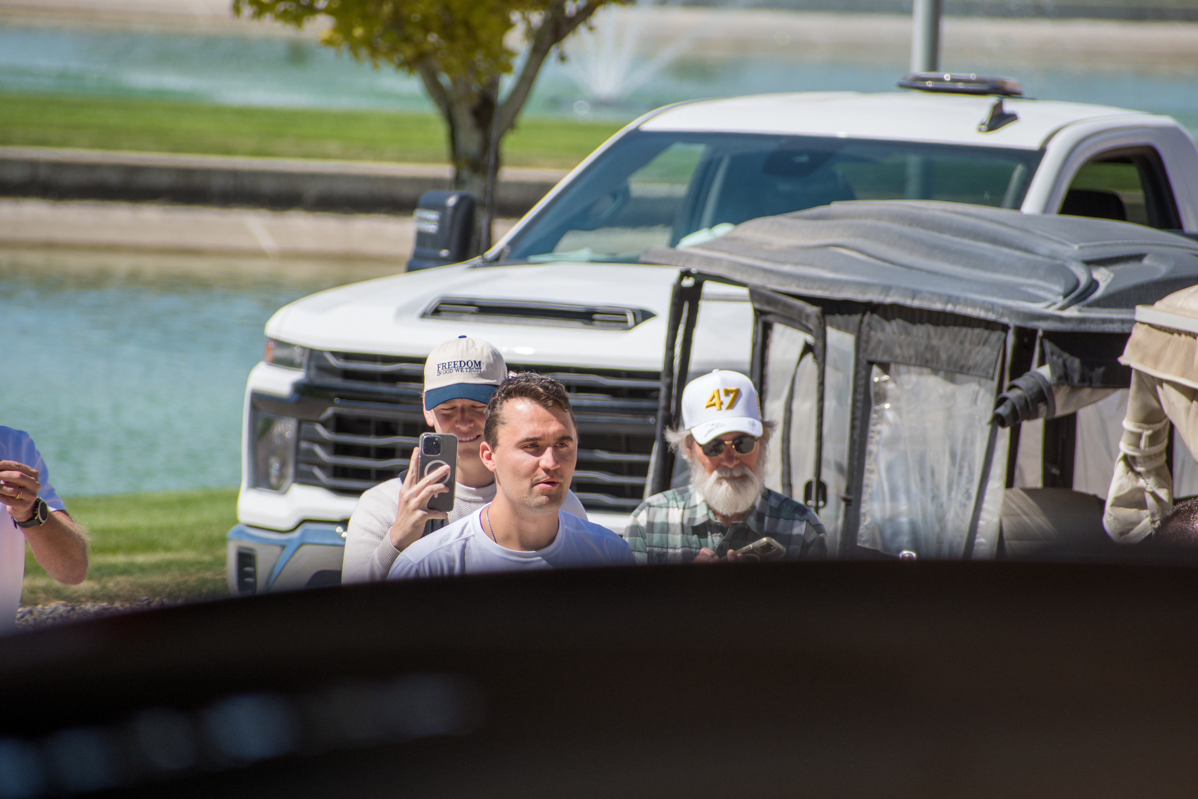 OREM, UTAH – SEPTEMBER 10, 2025: Charlie Kirk gestures while arriving at Utah Valley University for a scheduled public event. Surrounded by supporters and staff near a park-like setting, Kirk points toward the crowd in a moment of expressive engagement. The image marks the beginning of his final public appearance, reflecting anticipation, outreach, and symbolic presence. © Charles-McClintock Wilson / ZUMA Press