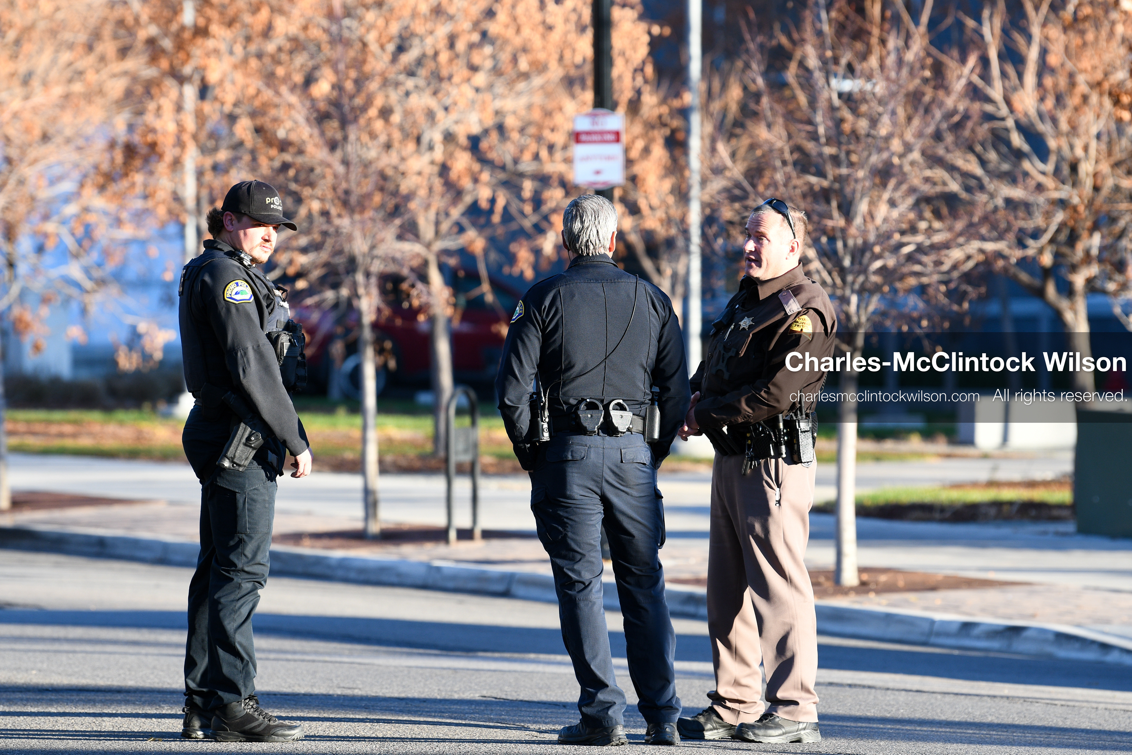 PROVO, UTAH, USA – DECEMBER 11, 2025: Two Provo Police officers and a Utah Highway Patrol officer stand outside the Fourth District Court in Provo during the first in‑person court appearance of Tyler Robinson in the Charlie Kirk murder case. (Credit Image: © Charles‑McClintock Wilson/ZUMA Press Wire)