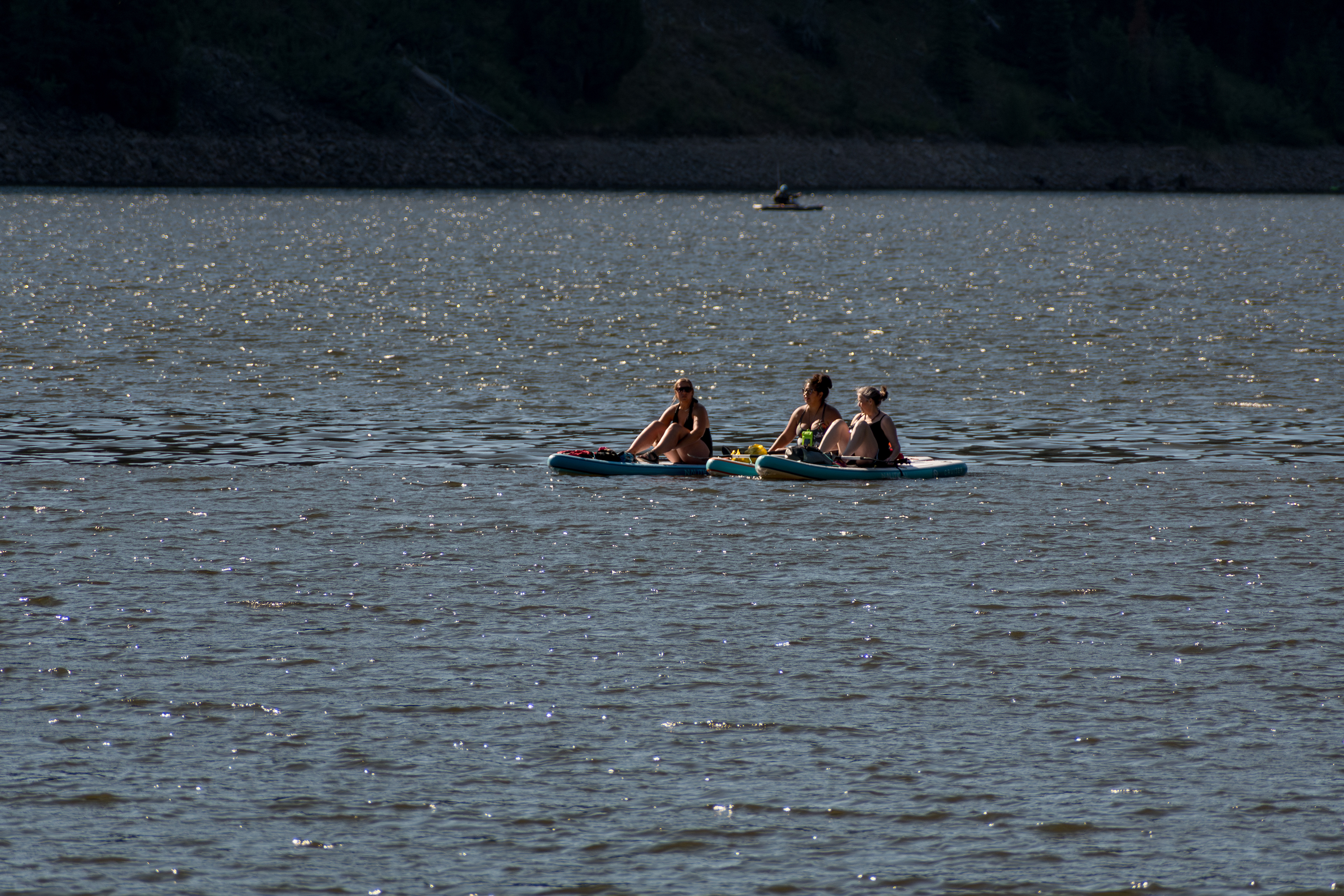 Summit County, Utah – July 20, 2025: People paddleboard across the calm waters of Smith and Morehouse Reservoir during a summer outing.