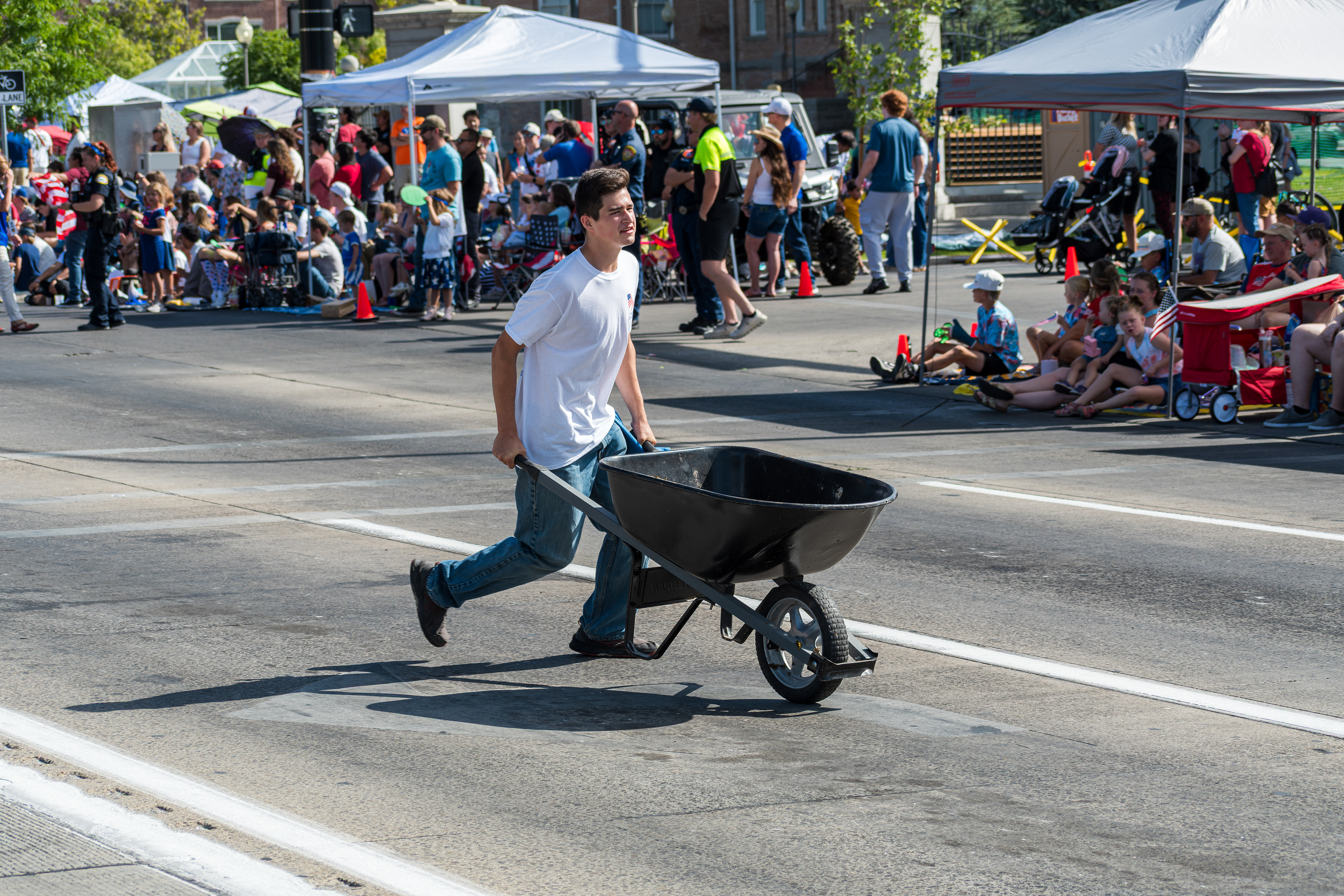 Provo, Utah – July 4, 2025: A man pushes a wheelbarrow along the parade route during the Freedom Festival Grand Parade in downtown Provo.