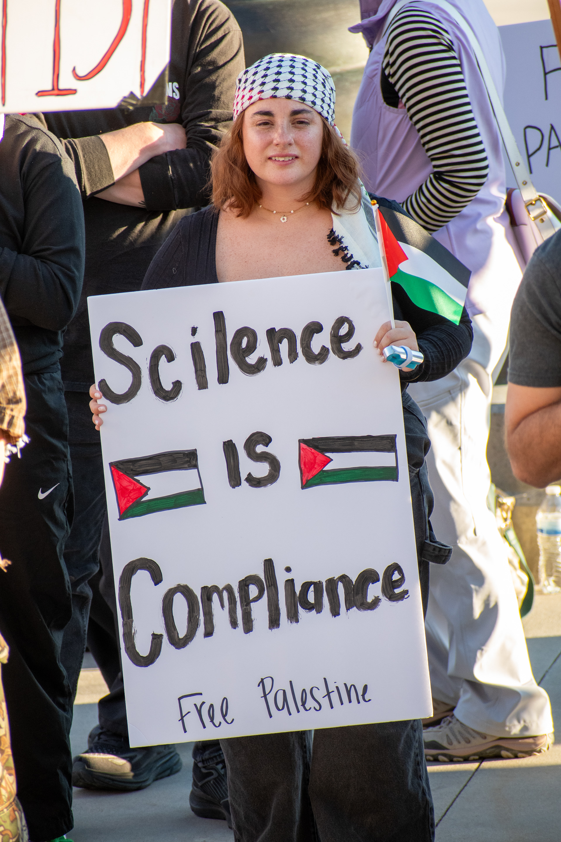  October 10, 2025, Salt Lake City, Utah, USA: A demonstrator holds a sign reading â€œScience is Compliance - Free Palestineâ€ during the Free Palestine Rally organized in front of the Utah State Capitol. Palestinian flags flank the message as participants gather in support of Palestinian rights. (Credit Image: © Charles-McClintock Wilson/ZUMA Press Wire)