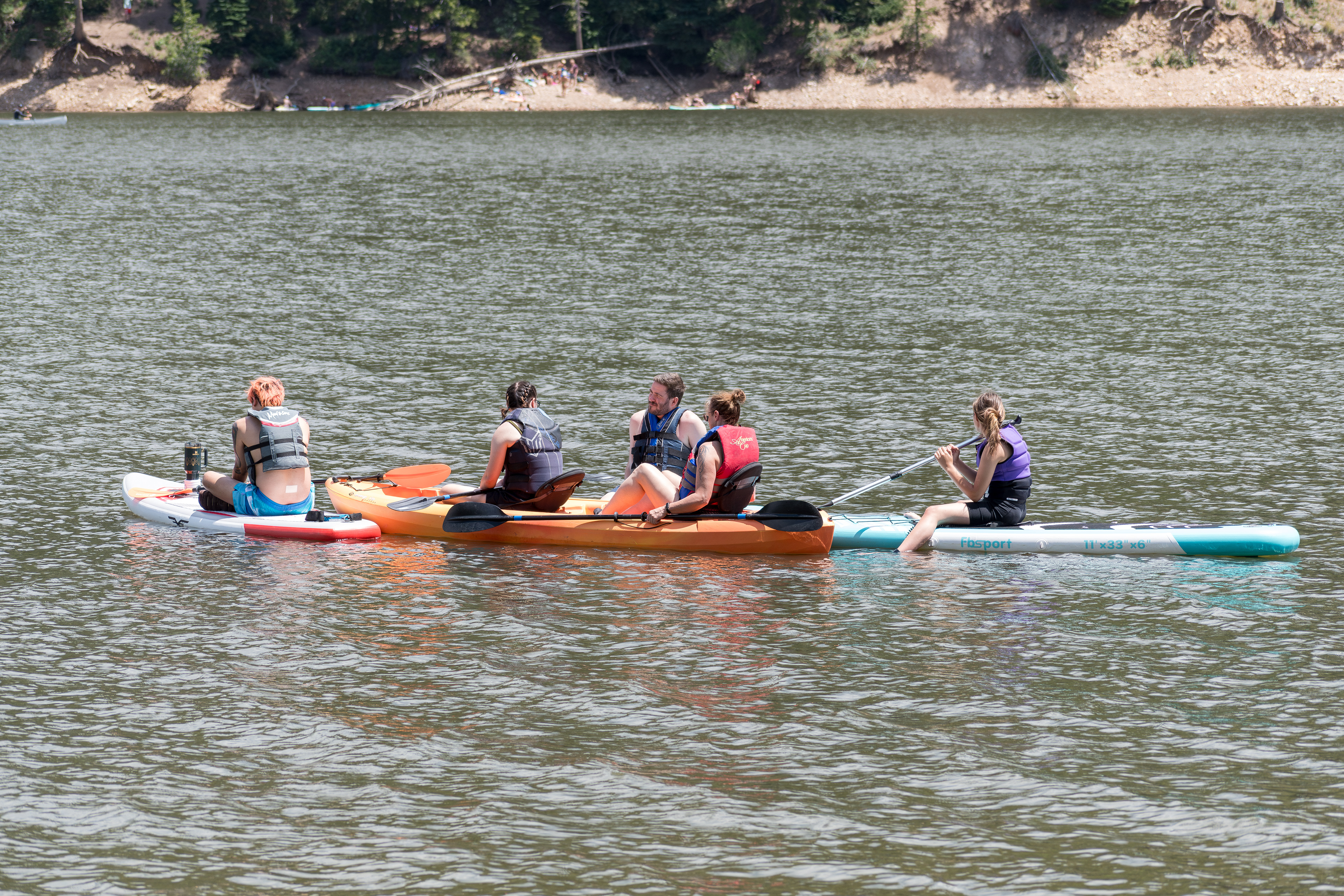 Summit County, Utah – July 20, 2025: People enjoy outdoor recreation on kayaks and paddleboards at Smith and Morehouse Reservoir.