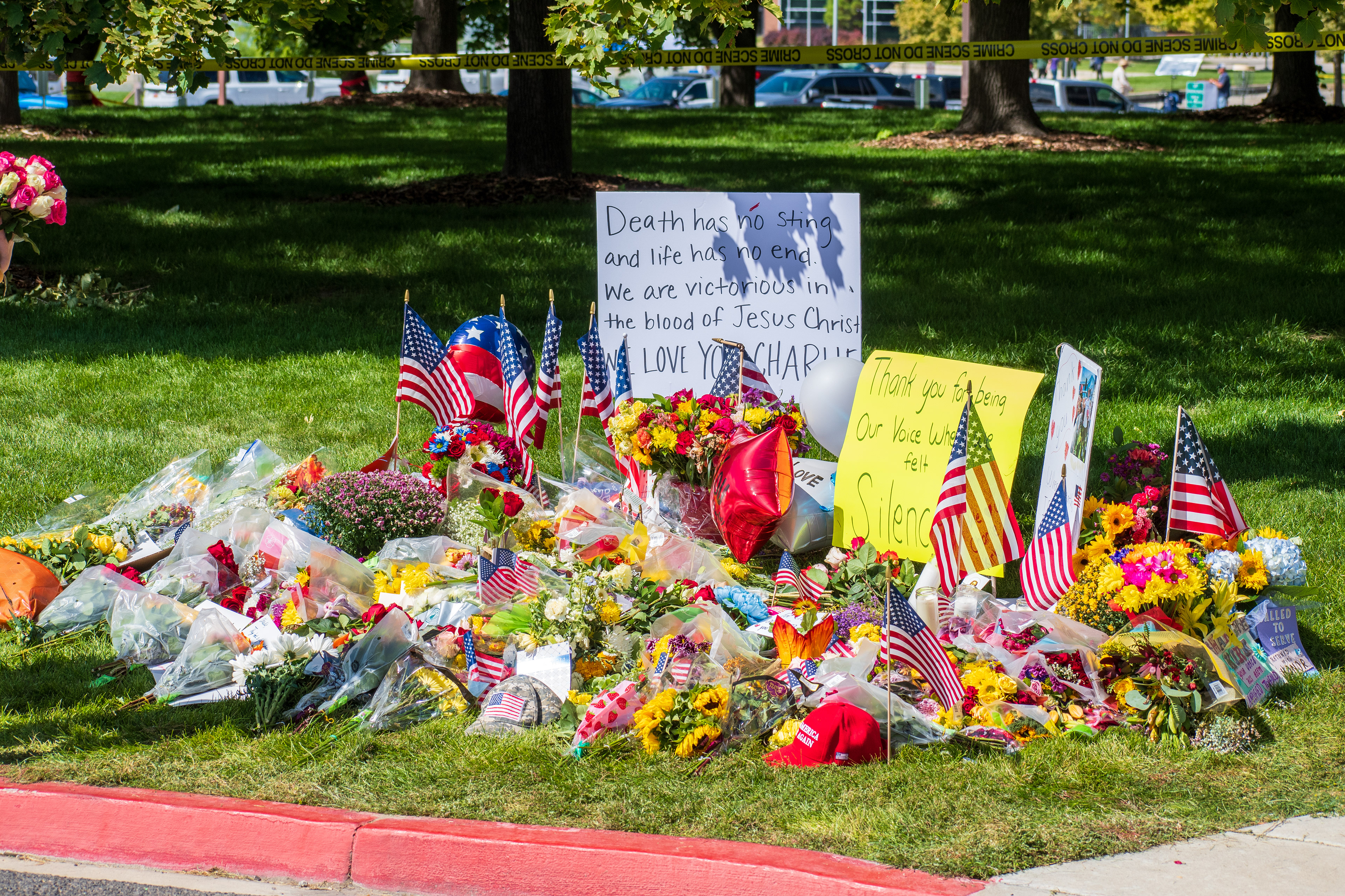 OREM, UTAH – SEPTEMBER 12, 2025: Flowers, American flags, balloons, and handwritten posters are arranged on a grassy memorial site for Charlie Kirk near Utah Valley University. The tribute reflects a collective expression of remembrance and community solidarity. © Charles‑McClintock Wilson / ZUMA Press