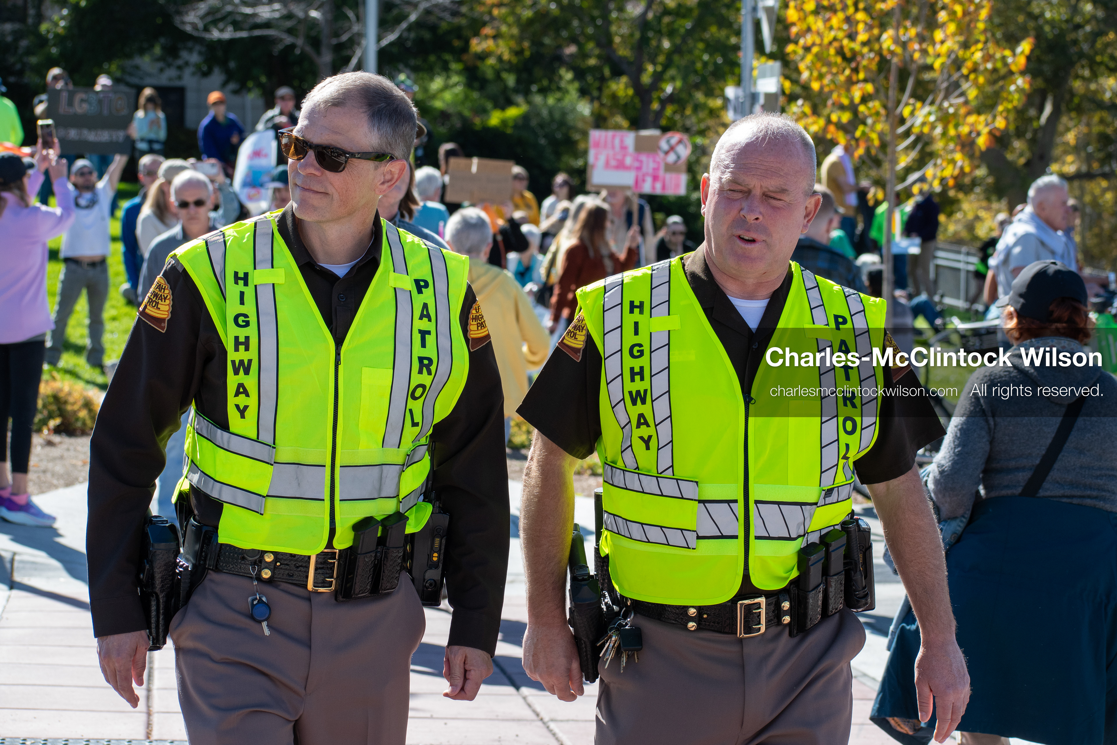 October 18, 2025, Salt Lake City, Utah, USA: Two Highway Patrol officers walk near demonstrators during a "No Kings" protest in Salt Lake City, Utah. The protest was part of a nationwide mobilization.