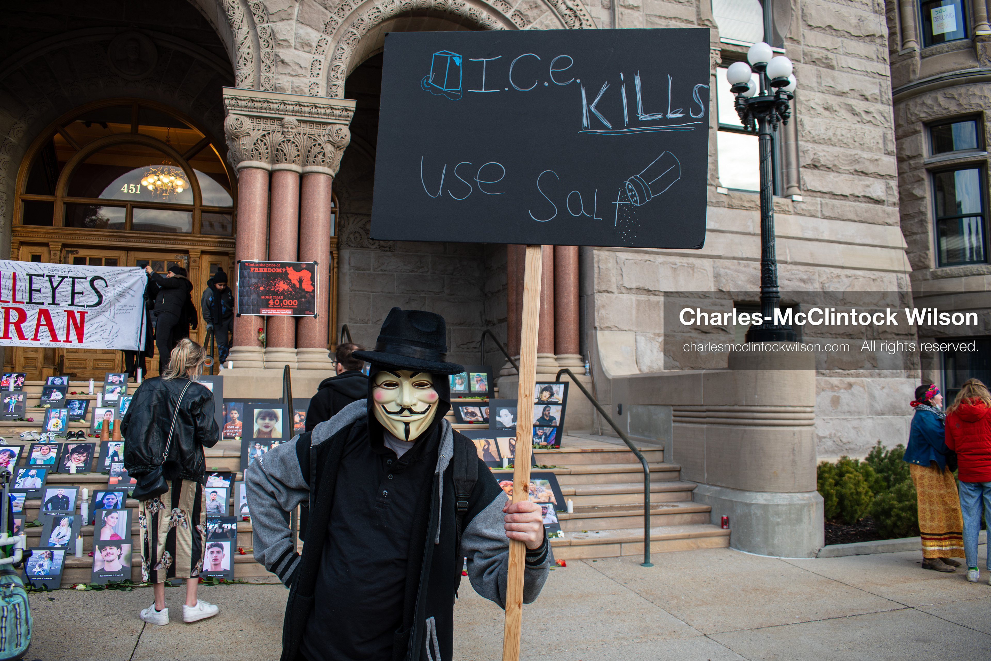 January 30, 2026, Salt Lake City, Utah, USA: A demonstrator stands in front of portraits and a banner during a vigil honoring victims of the Iranian government at the Salt Lake City and County Building. (Credit Image: © Charles McClintock Wilson/ZUMA Press Wire)