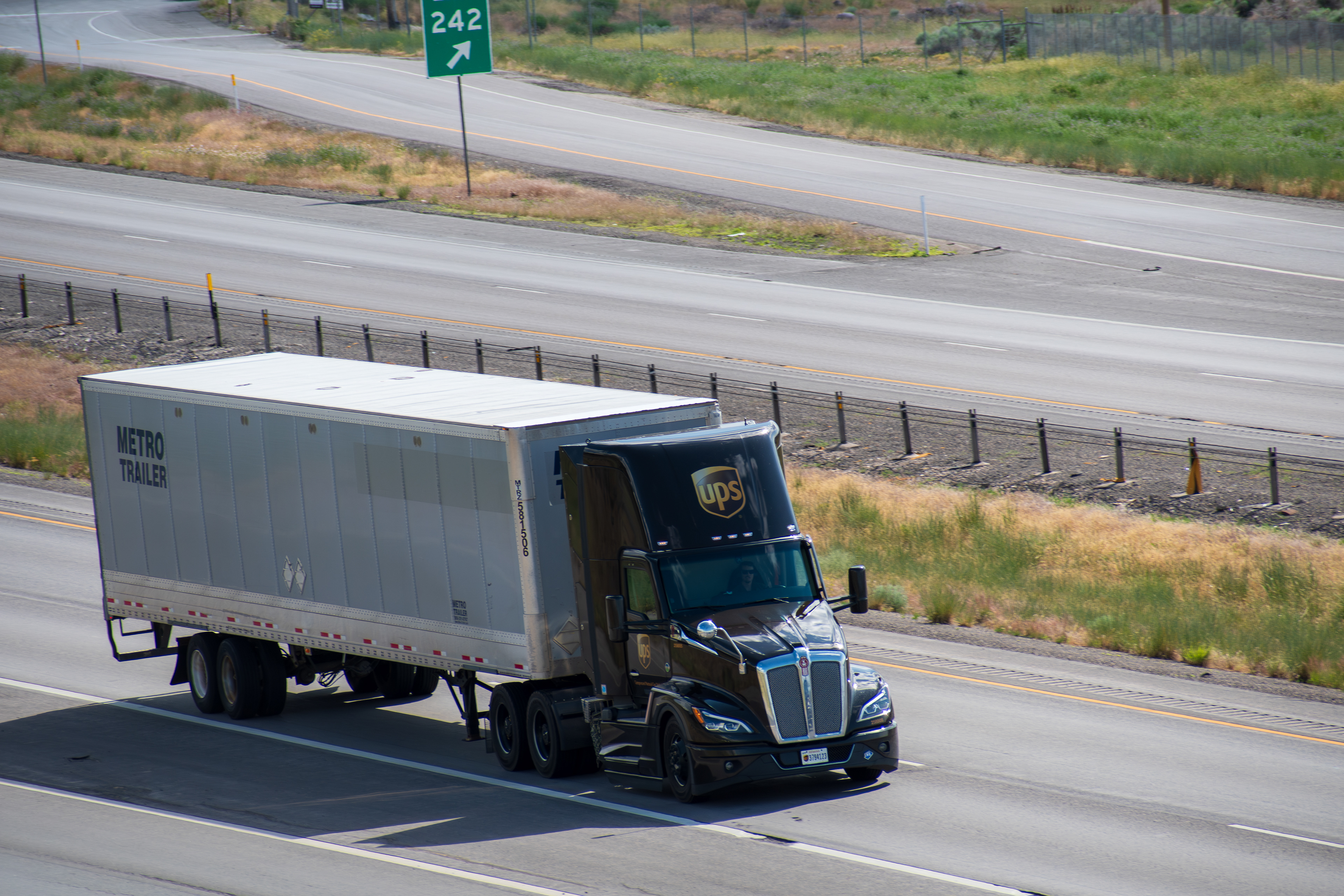 SANTAQUIN, UT – JUNE 8, 2025: A UPS truck with a single trailer drives northbound on I-15 in Santaquin, Utah. UPS is an American multinational shipping and logistics company founded in 1907.