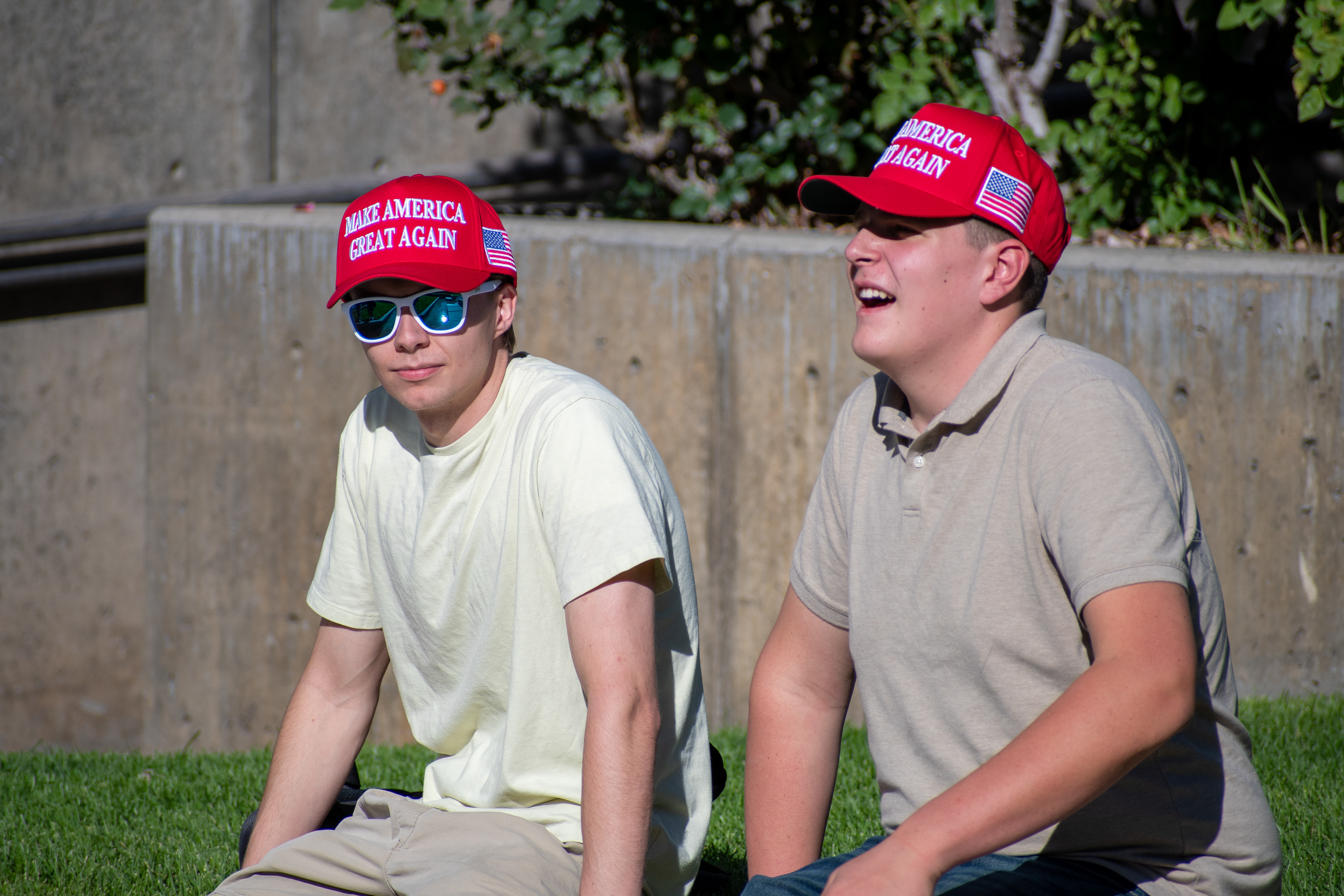 OREM, UTAH – SEPTEMBER 10, 2025: Two attendees sit on the lawn at Utah Valley University during the opening stop of the American Comeback Tour. Framed in relaxed conversation and reflective posture, the image captures a moment of casual presence, shared energy, and civic engagement. © Charles-McClintock Wilson / ZUMA Press