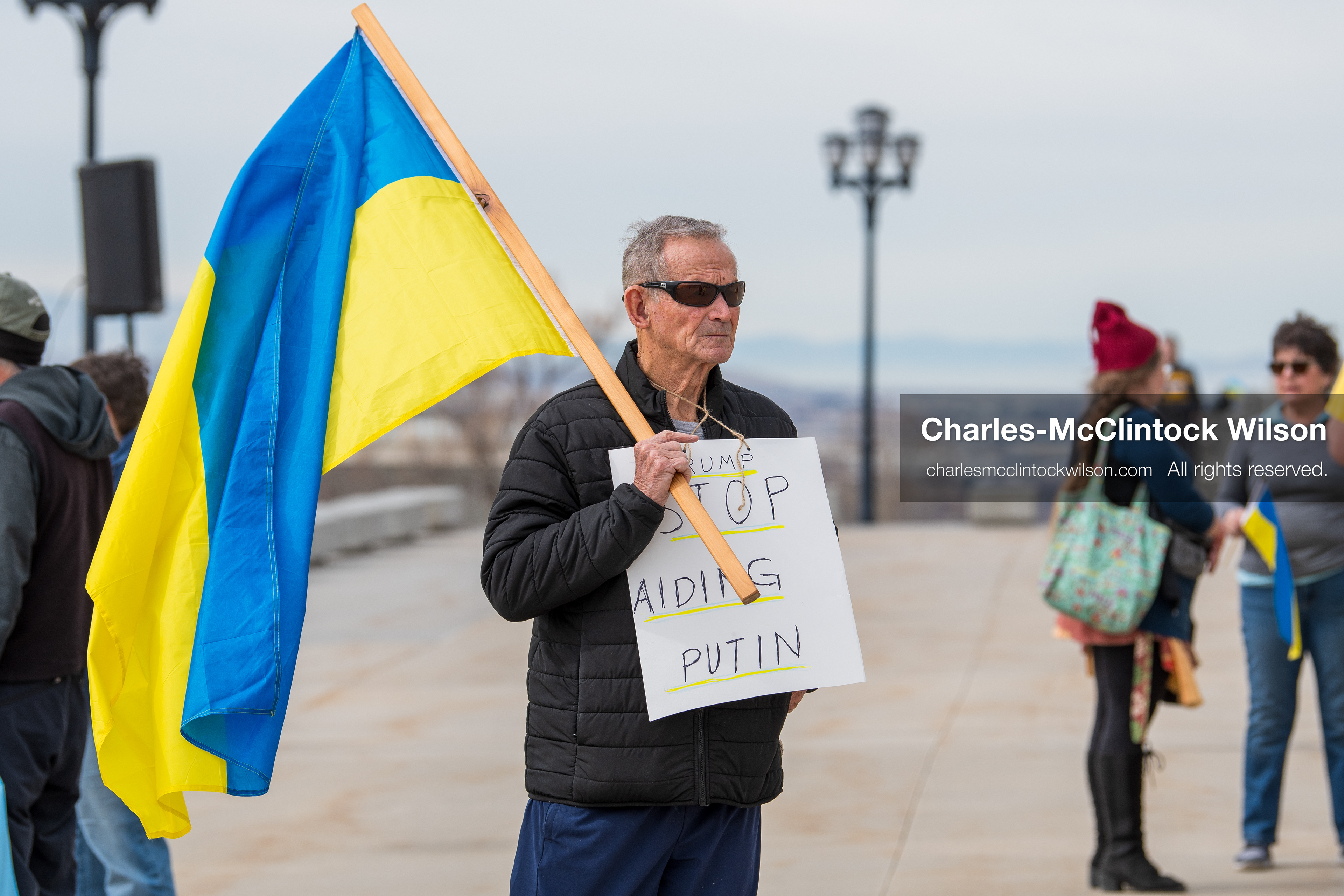 February 28, 2026, Salt Lake City, Utah, USA: A demonstrator wears a sign reading Trump Stop Aiding Putin during the Stand With Ukraine rally at the Utah State Capitol. The gathering marked the four year anniversary of the full scale Russian invasion of Ukraine and brought community members together in support of Ukrainians and local humanitarian efforts. (Credit Image: © Charles McClintock Wilson/ZUMA Press Wire)