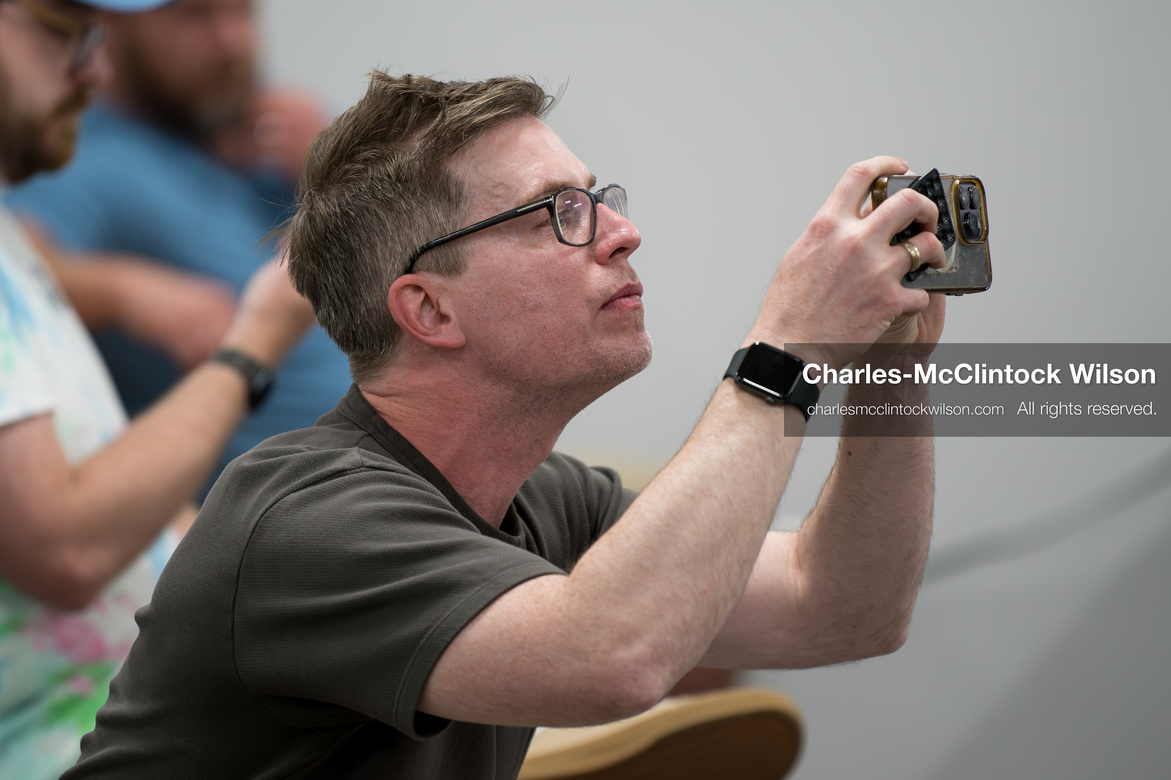 May 13, 2026, Brigham City, Utah, USA: US political satirist and digital creator WALTER MASTERSON records video on his phone inside the Box Elder County Justice Center in Brigham City, Utah, during a public meeting over the proposed data‑center project backed by businessman Kevin O’Leary, which has drawn public concern over water use, power demand, and transparency. (Credit Image: © Charles‑McClintock Wilson/ZUMA Press Wire)