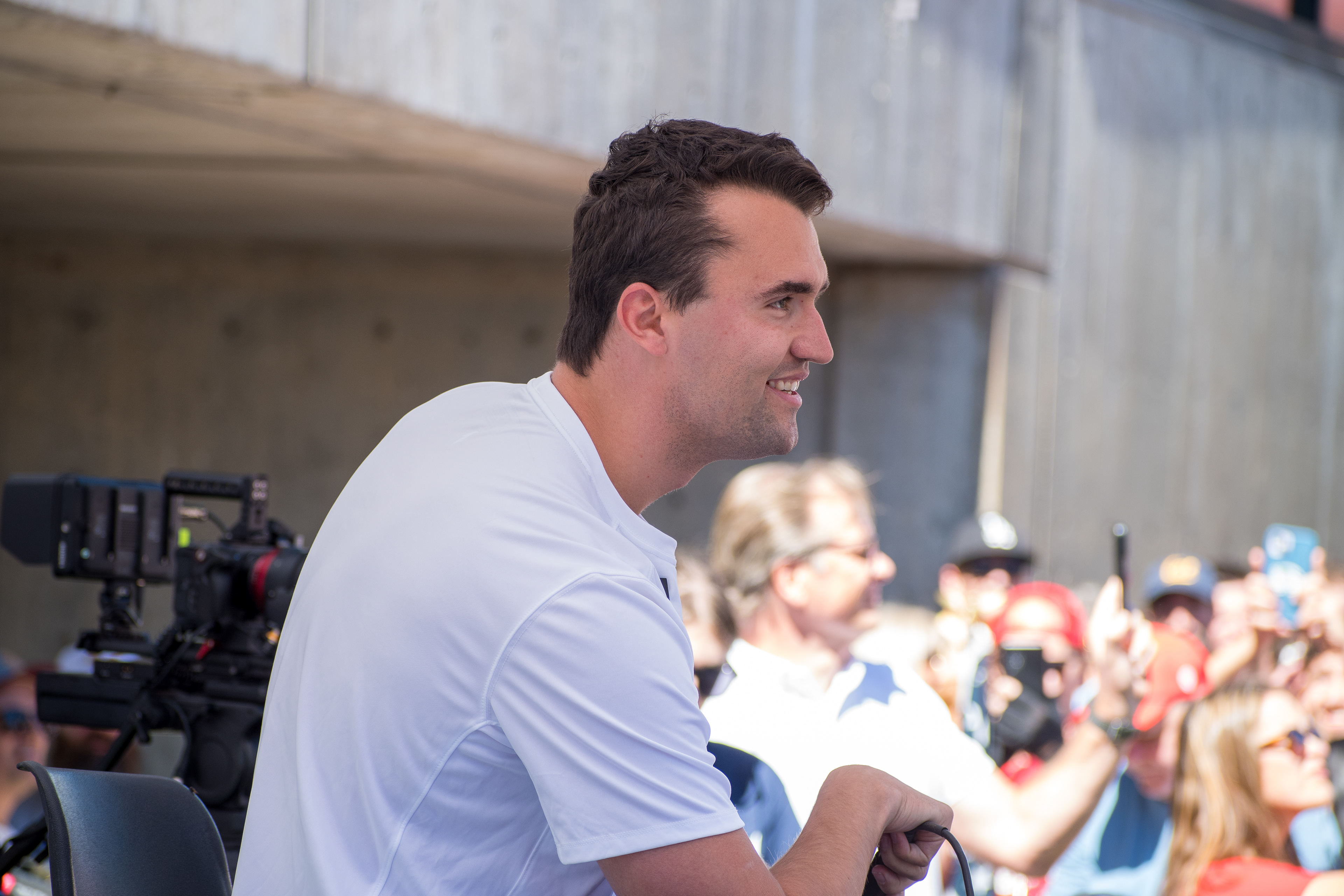 OREM, UTAH – SEPTEMBER 10, 2025: Charlie Kirk smiles while interacting with supporters during a public event at Utah Valley University. Seated among attendees and surrounded by cameras and onlookers, Kirk appears engaged and at ease in one of his final public moments before the shooting incident that disrupted the gathering. The image reflects a rare moment of levity and connection amid a politically charged atmosphere. © Charles-McClintock Wilson / ZUMA Press