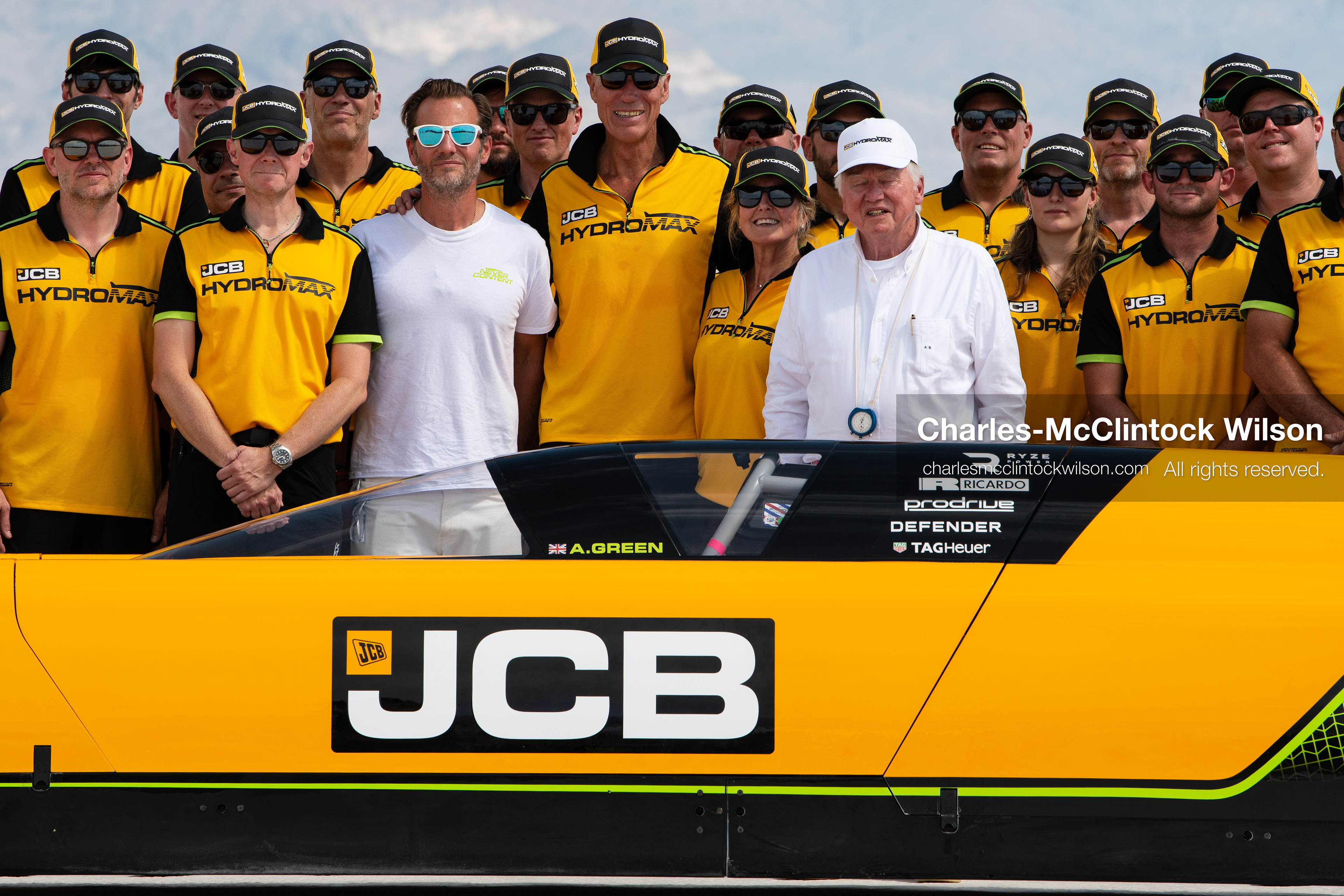 British pilot Andy Green and JCB Chairman Anthony Bamford stand alongside members of the JCB engineering team behind the cockpit of the "JCB Hydromax" on the Bonneville Salt Flats on Tuesday. The team posed together after securing a new hydrogen land speed record of 406.320 mph. (Photo by Charles-McClintock Wilson/Sipa USA)